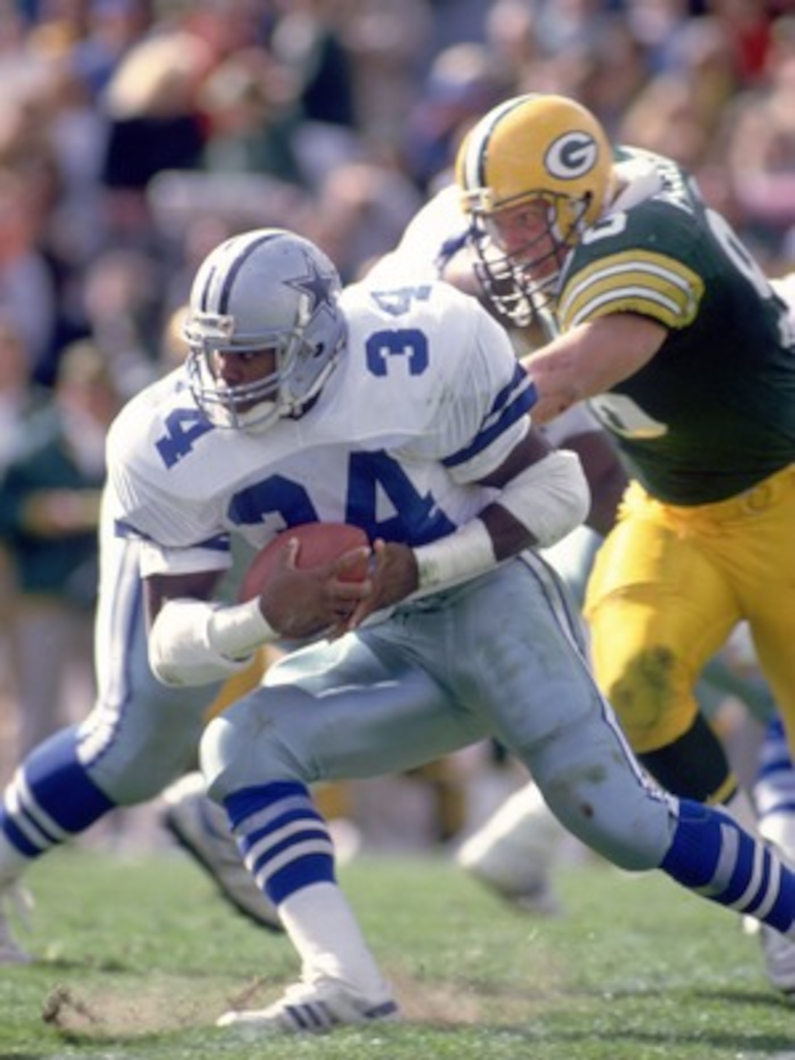 GREEN BAY, WI - OCTOBER 8: Running back Herschel Walker #34 of the Dallas Cowboys makes a cut up field to avoid the pursuing defense of the Green Bay Packers during the Cowboys 31-13 loss to the Packers on October 8, 1989 at Lambeau Field in Green Bay, W GREEN BAY, WI - OCTOBER 8: Running back Herschel Walker #34 of the Dallas Cowboys makes a cut up field to avoid the pursuing defense of the Green Bay Packers during the Cowboys 31-13 loss to the Packers on October 8, 1989 at Lambeau Field in Green Bay, W