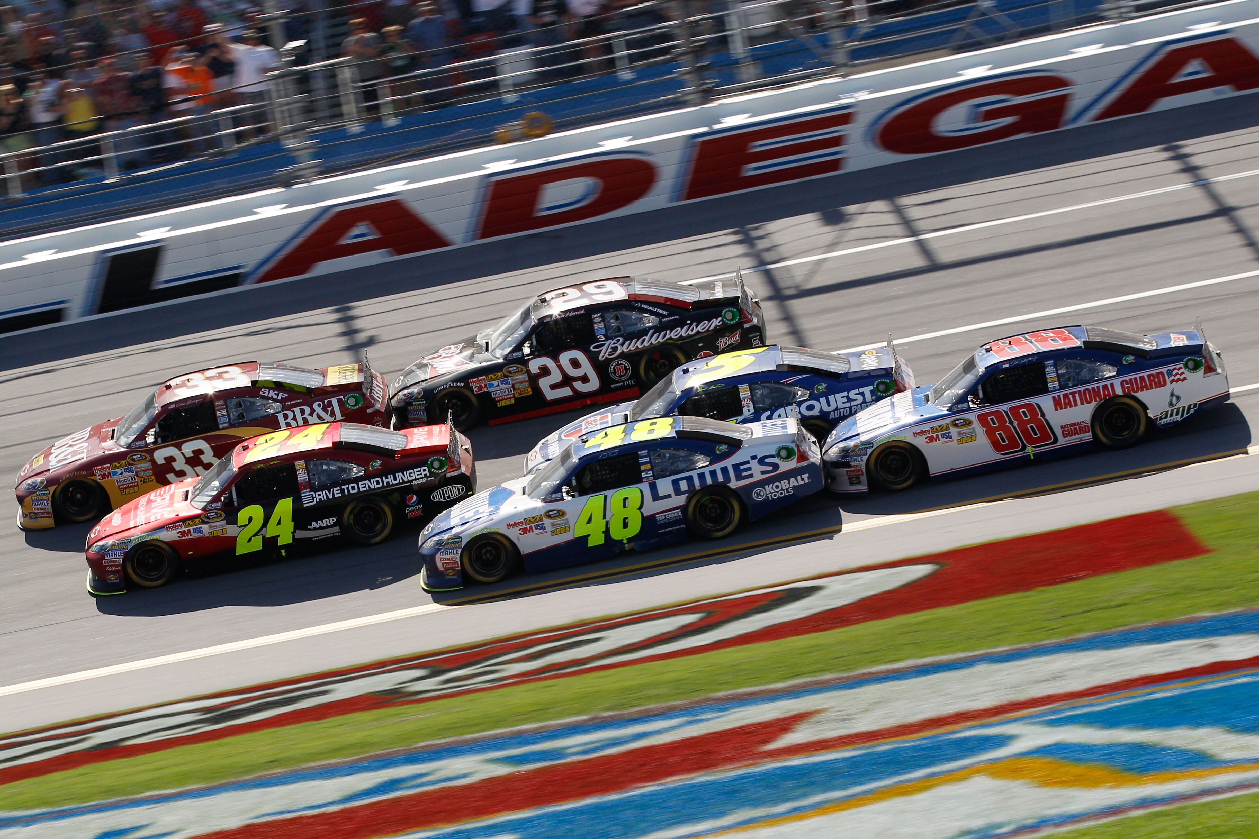 TALLADEGA, AL - APRIL 17:  Clint Bowyer, driver of the #33 BB&T Chevrolet, Jeff Gordon, driver of the #24 Drive to End Hunger/AARP Chevrolet, and Jimmie Johnson, driver of the #48 Lowe's Chevrolet, lead Kevin Harvick, driver of the #29 Budweiser Chevrolet