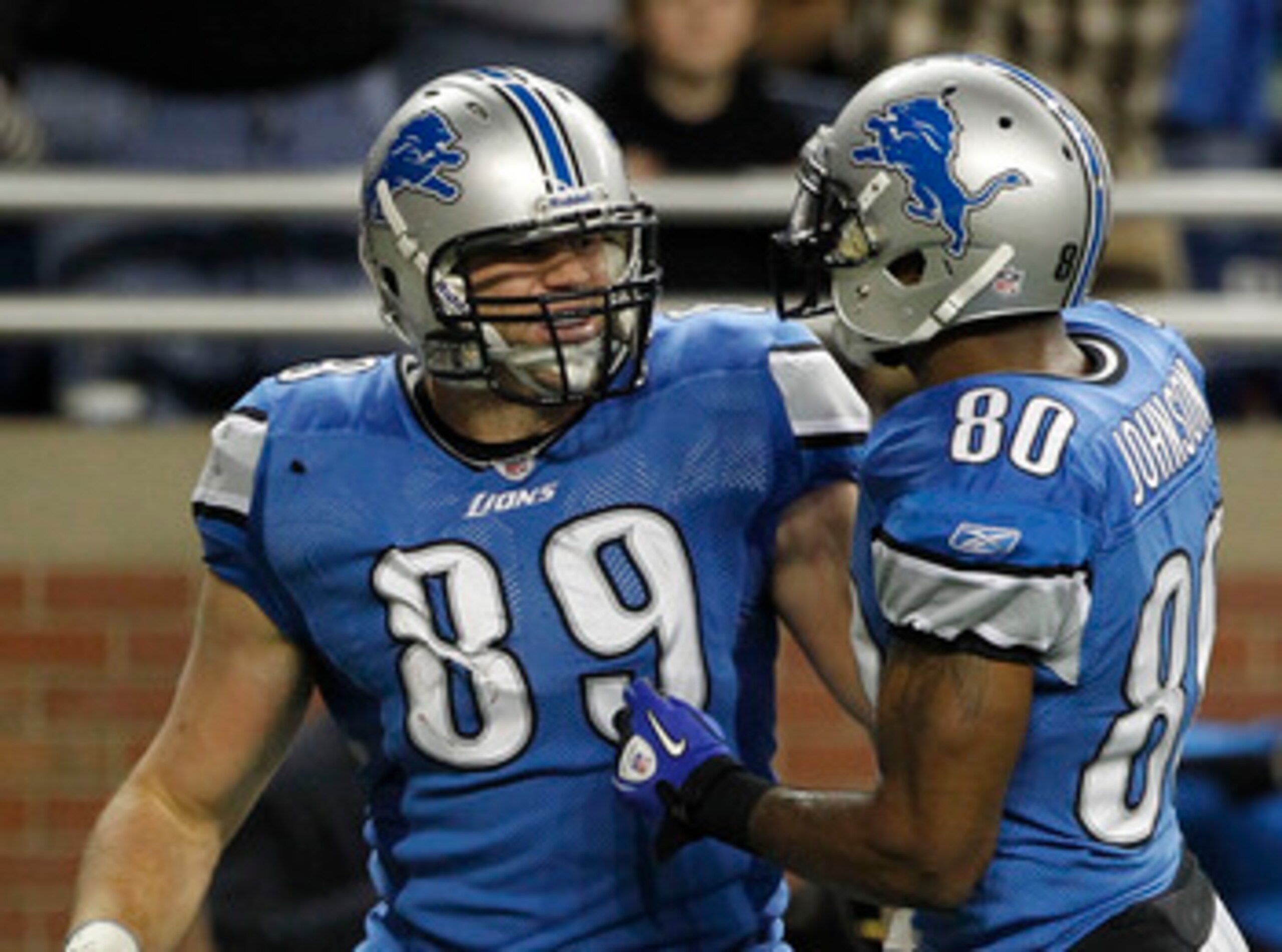 DETROIT - DECEMBER 12: Will Heller #89 of the Detroit Lions is congratulated by teammate Bryant Johnson #80 after scoring a fourth quarter touchdown during the game against the Green Bay Packers at Ford Field on December 12, 2010 in Detroit, Michigan. The DETROIT - DECEMBER 12: Will Heller #89 of the Detroit Lions is congratulated by teammate Bryant Johnson #80 after scoring a fourth quarter touchdown during the game against the Green Bay Packers at Ford Field on December 12, 2010 in Detroit, Michigan. The