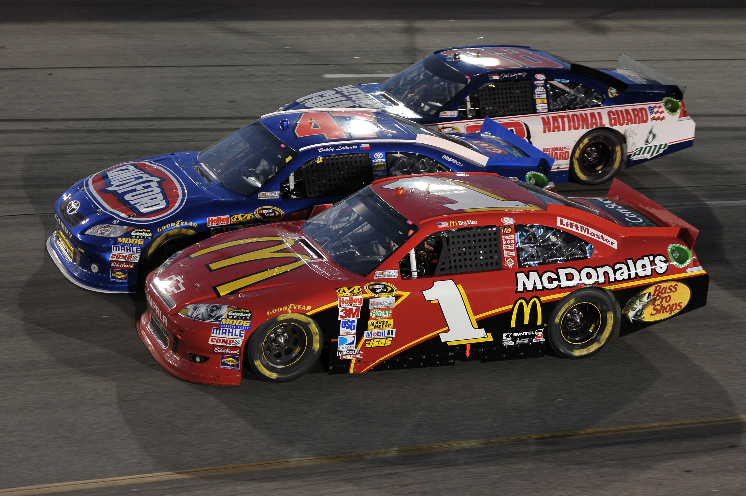 RICHMOND, VA - APRIL 30:  Jamie McMurray, driver of the #1 McDonald's Chevrolet, Bobby Labonte, driver of the #47 Kingsford Toyota, and Dale Earnhardt Jr., driver of the #88 National Guard/Amp Energy Chevrolet, race during the NASCAR Sprint Cup Series Cro