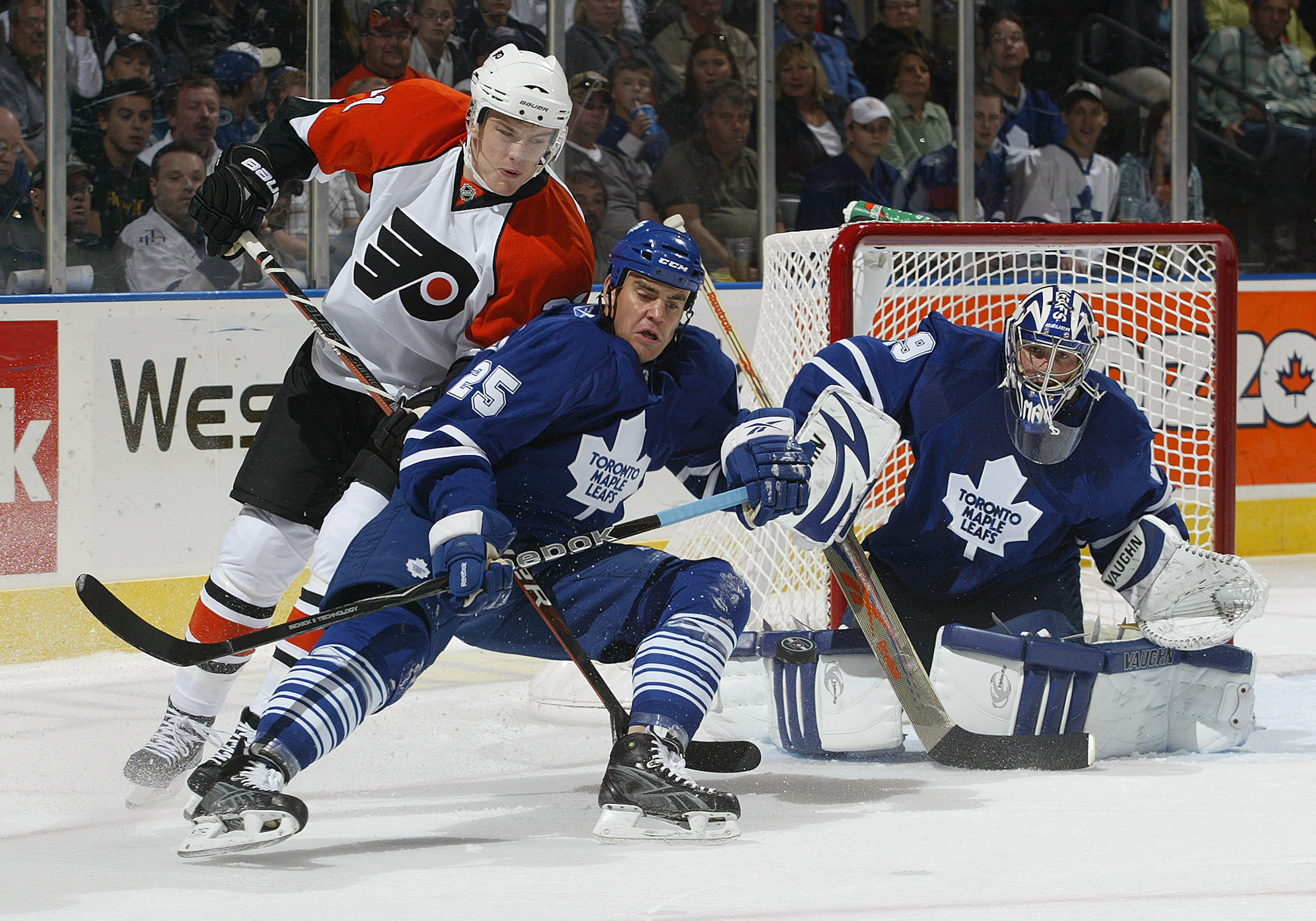 LONDON, ON - SEPTEMBER 17:  Ben Ondrus #25 and Joey MacDonald  #29 of the Toronto Maple Leafs watch an incoming shot while Ondrus tries to hold up James Van Reimsdyk #21 of the Philadelphia Flyers in a pre-season game  on September 17, 2009 at the John La