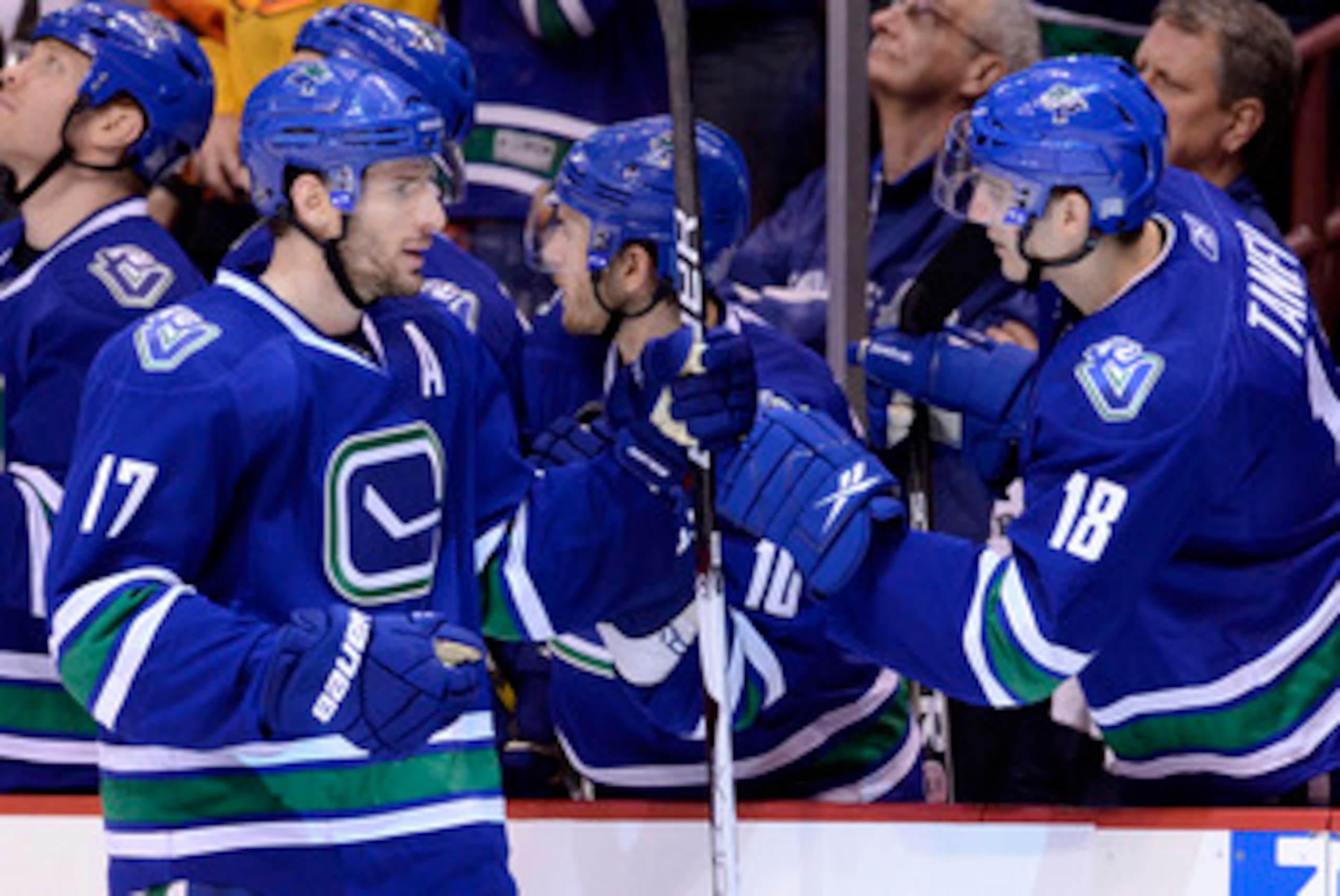 VANCOUVER, CANADA - JANUARY 22: Ryan Kesler #17 of the Vancouver Canucks is congratulated by teammate Chris Tanev #18 after scoring against the Calgary Flames during the third period in NHL action on January 22, 2011 at Rogers Arena in Vancouver, BC, Cana