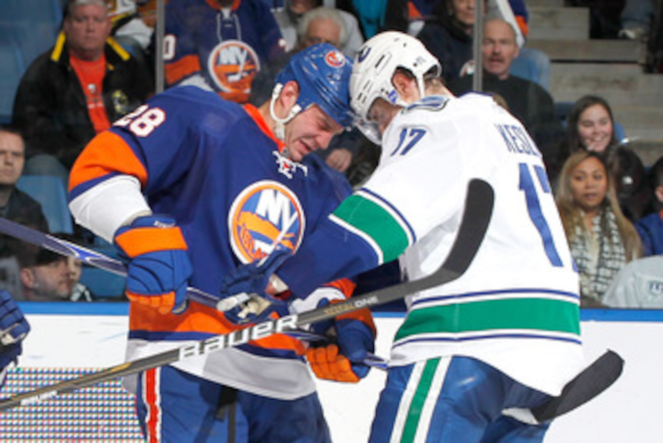 UNIONDALE, NY - JANUARY 11: Ryan Kesler #17 of the Vancouver Canucks butts heads with Zenon Konopka #28 of the New York Islanders during an NHL game at the Nassau Coliseum on January 11, 2011 in Uniondale, New York.  (Photo by Paul Bereswill/Getty Images)