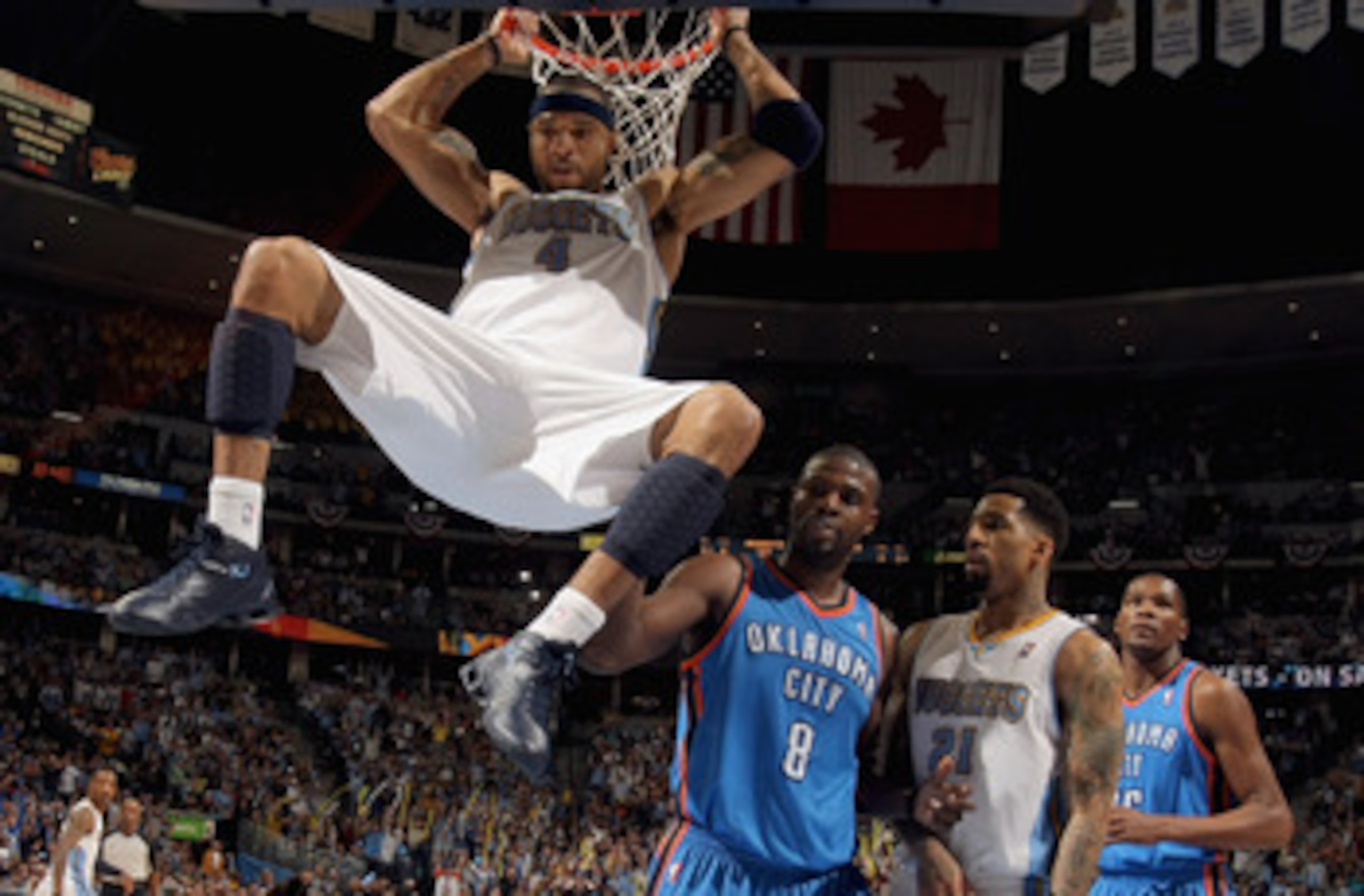 DENVER, CO - APRIL 23:  Kenyon Martin #4 of the Denver Nuggets dunks the ball as Nazr Mohammed #8 of the Oklahoma City Thunder, Wilson Chandler #21 of the Denver Nuggets and Kevin Durant #35 of the Oklahoma City Thunder look on in Game Three of the Wester