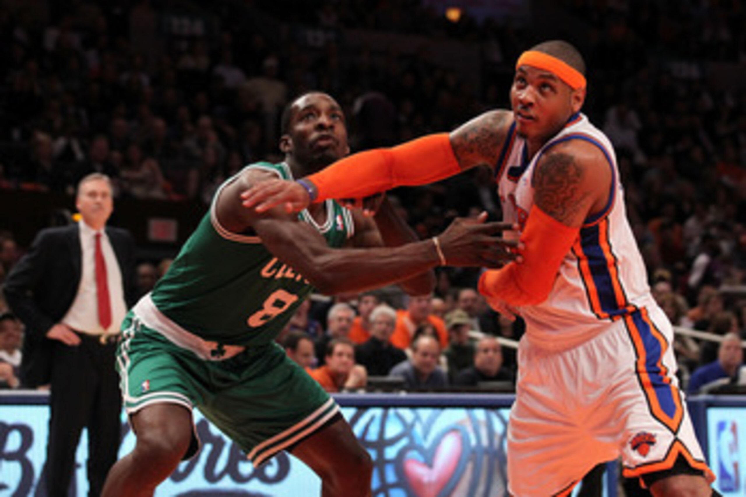 NEW YORK, NY - APRIL 22:  Carmelo Anthony #7 of the New York Knicks fights for rebound position against Jeff Green #8 of the Boston Celtics as Knicks head coach Mike D'Antoni (L) in the first half of Game Three of the Eastern Conference Quarterfinals in t