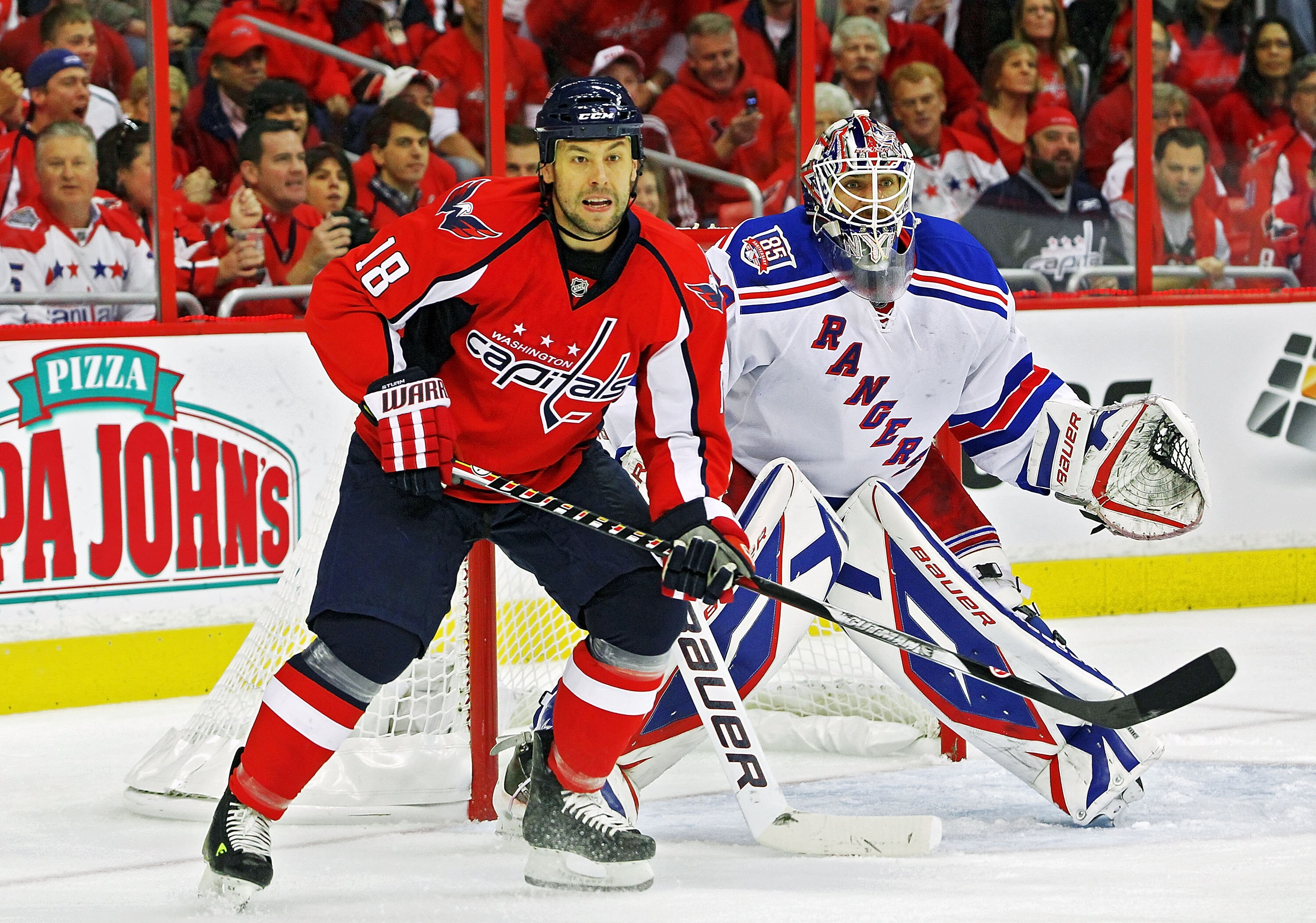 WASHINGTON , DC - APRIL 23: Marco Sturm #18 of the Washington Capitals skates in front of Henrik Lundqvist #30 of the New York Rangers in Game Five of the Eastern Conference Quarterfinals during the 2011 NHL Stanley Cup Playoffs at the Verizon Center on A