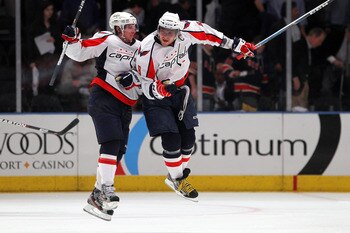 NEW YORK, NY - APRIL 20:  (L-R) Nicklas Backstrom #19 and Alex Ovechkin #8 of the Washington Capitals celebrate after they won 4-3 in the second overtime against the New York Rangers in Game Four of the Eastern Conference Quarterfinals during the 2011 NHL