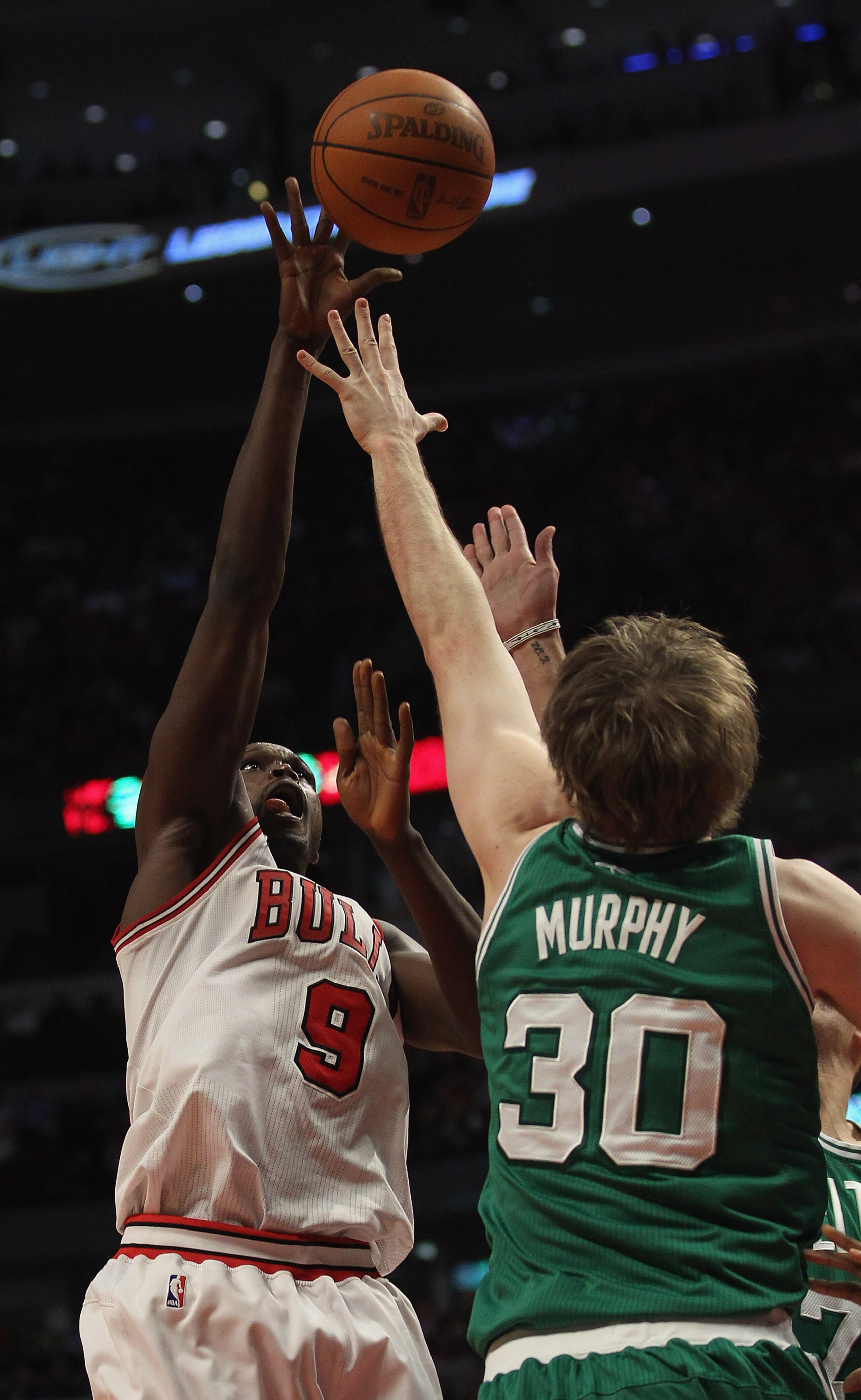 CHICAGO, IL - APRIL 07: Loul Deng #9 of the Chicago Bulls puts up a shot over Troy Murphy #30 of the Boston Celtics at United Center on April 7, 2011 in Chicago, Illinois. The Bulls defeated the Celtics 97-81. NOTE TO USER: User expressly acknowledges and CHICAGO, IL - APRIL 07: Loul Deng #9 of the Chicago Bulls puts up a shot over Troy Murphy #30 of the Boston Celtics at United Center on April 7, 2011 in Chicago, Illinois. The Bulls defeated the Celtics 97-81. NOTE TO USER: User expressly acknowledges and
