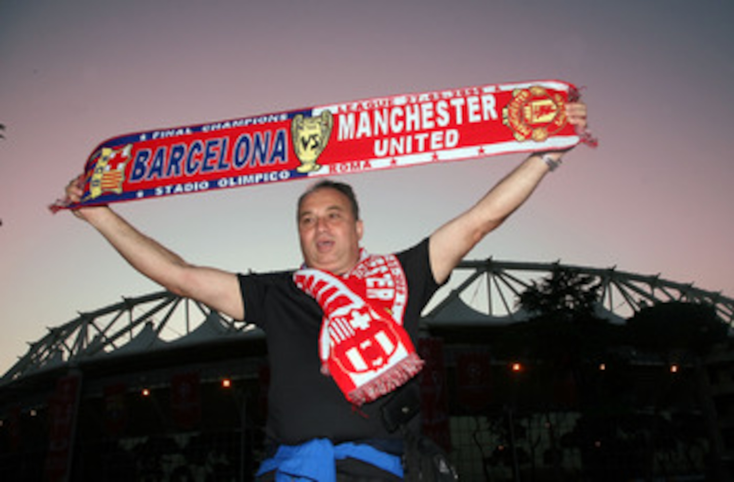 ROME - MAY 26: A Manchester United fan poses in front the Stadio Olimpico ahead of the UEFA Champions League Final between Barcelona and and Manchester United at the Stadio Olimpico on May 26, 2009 in Rome, Italy. (Photo by Franco Origlia/Getty Images) ROME - MAY 26: A Manchester United fan poses in front the Stadio Olimpico ahead of the UEFA Champions League Final between Barcelona and and Manchester United at the Stadio Olimpico on May 26, 2009 in Rome, Italy. (Photo by Franco Origlia/Getty Images)