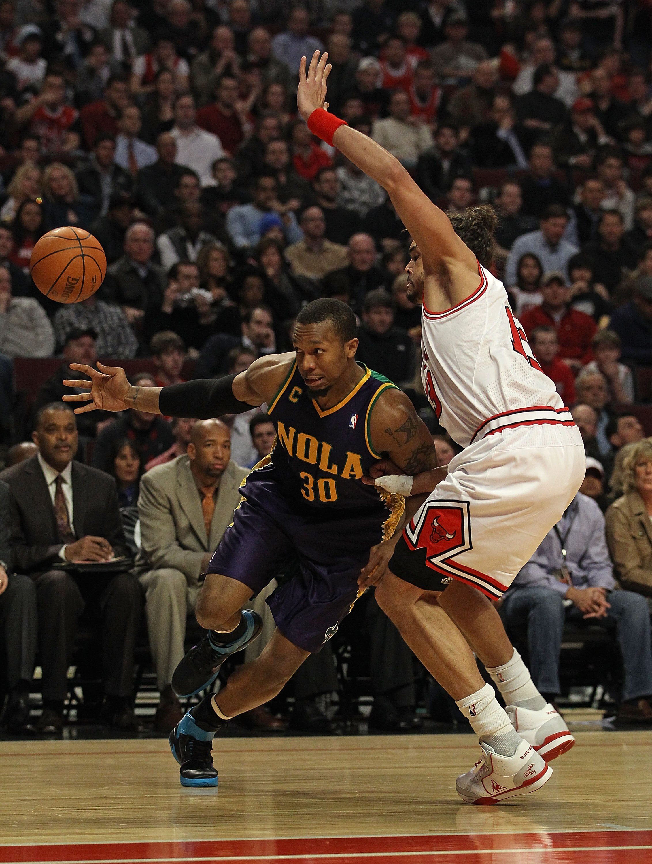CHICAGO, IL - MARCH 07: David West #30 of the New Orleans Hornets looses control of the ball under pressure from Joakim Noah #13 of the Chicago Bulls at the United Center on March 7, 2011 in Chicago, Illinois. NOTE TO USER: User expressly acknowledges and
