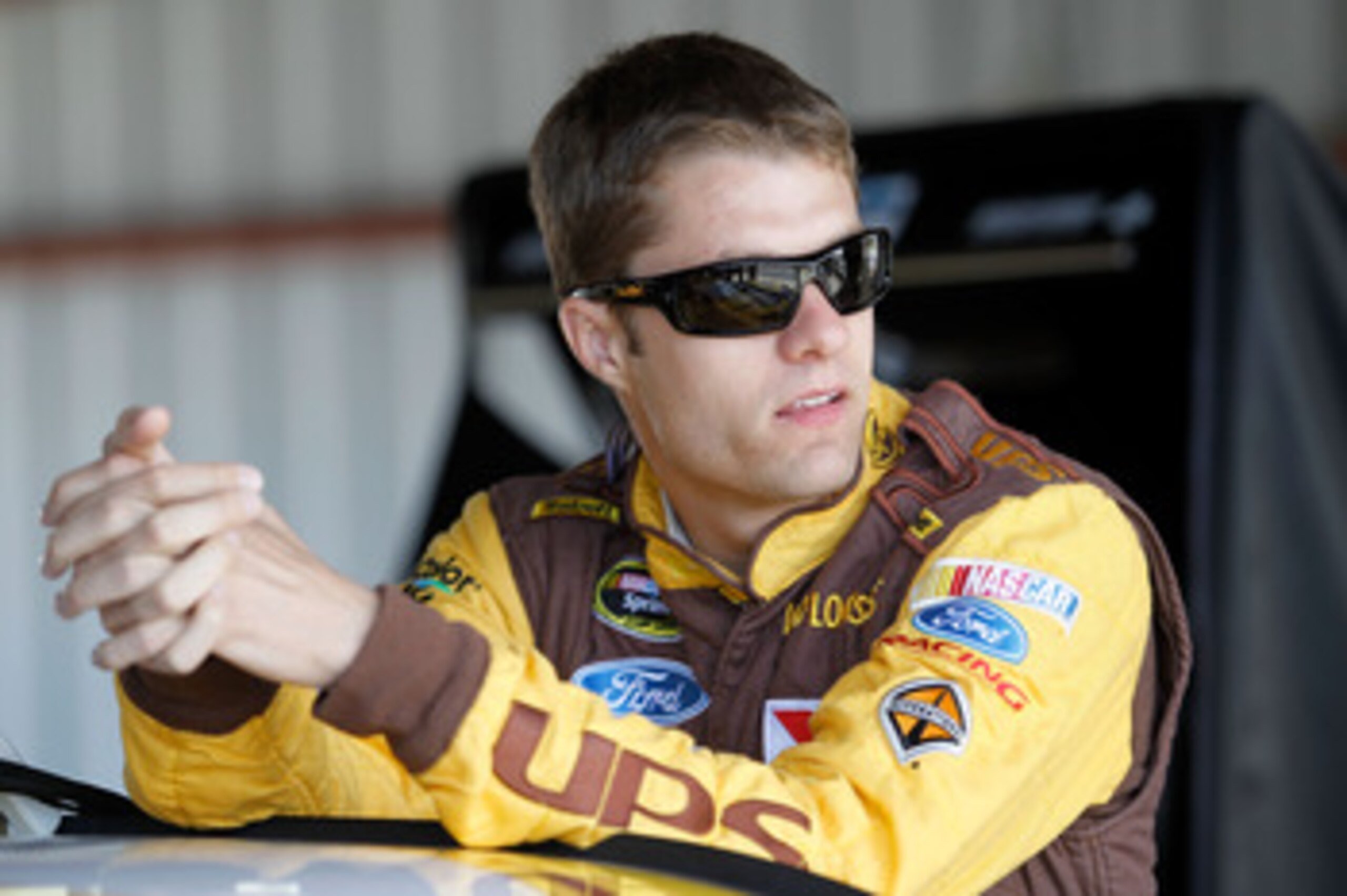 RICHMOND, VA - APRIL 29:  David Ragan, driver of the #6 UPS Ford, stands in the garage area during practice for the NASCAR Sprint Cup Series Crown Royal Presents The Matthew & Daniel Hansen 400 at Richmond International Raceway on April 29, 2011 in Richmo