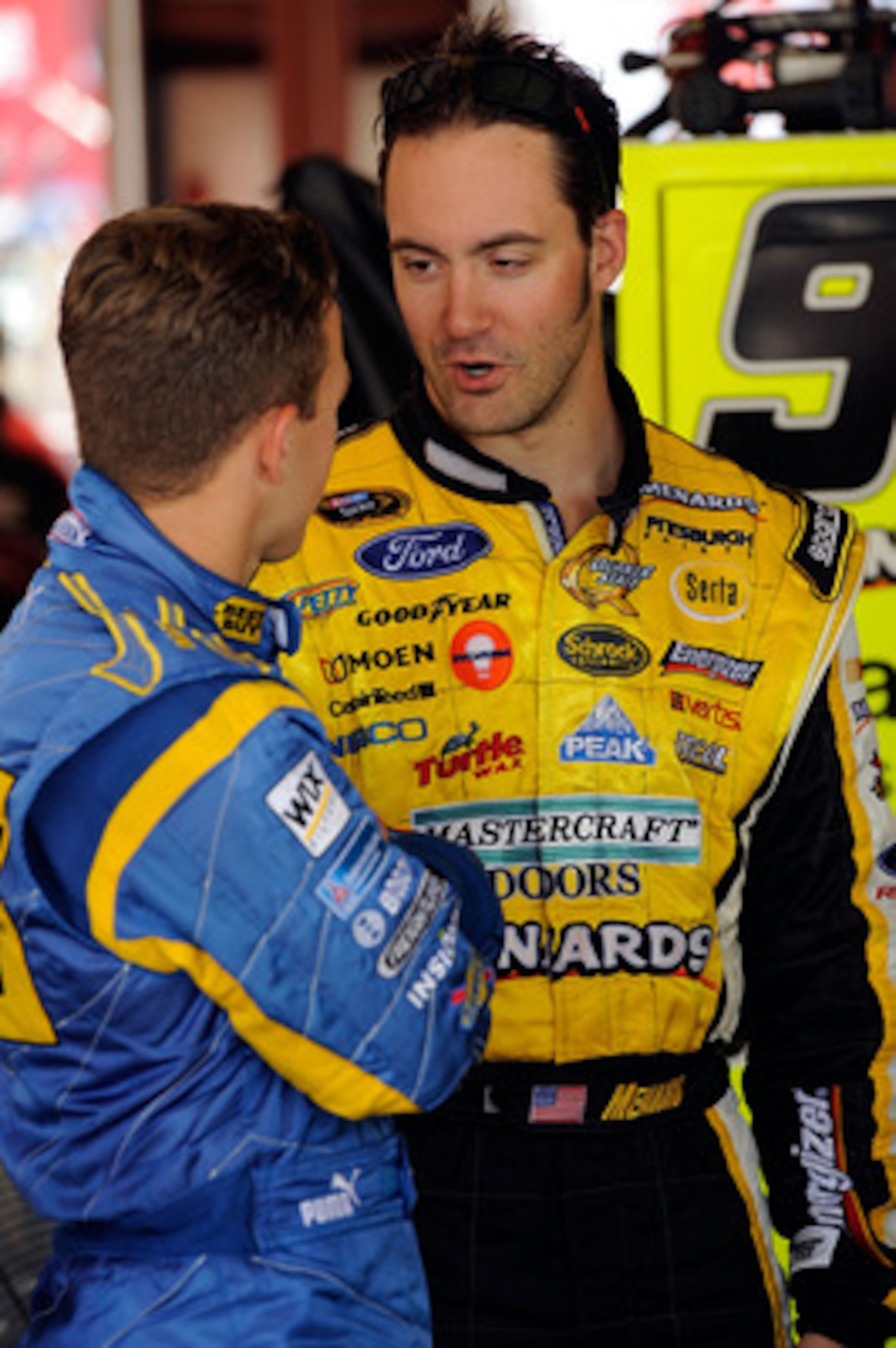 JOLIET, IL - JULY 09:  Paul Menard, driver of the #98 Moen / Menards Ford talks with AJ Allmendinger, driver of the #43 Geek Squad Ford during practice for the NASCAR Sprint Cup Series LIFELOCK.COM 400 at the Chicagoland Speedway on July 9, 2010 in Joliet