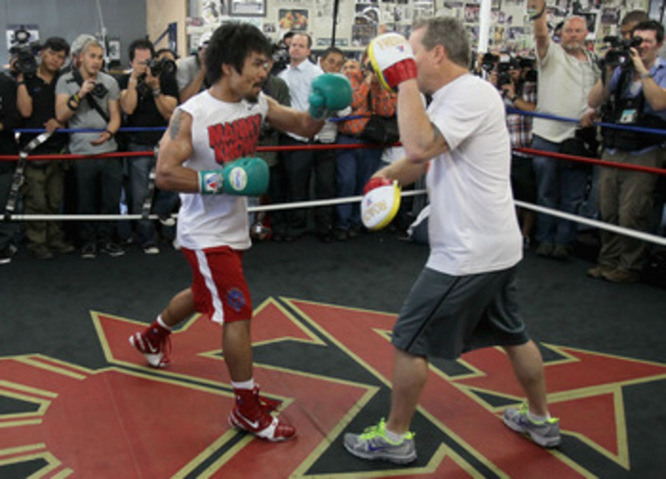 HOLLYWOOD, CA - APRIL 20:  Manny Pacquiao (L) of the Philippines spars with his coach Freddie Roach (R) during a media workout at the Wild Card Boxing Club on April 20, 2011 in Hollywood, California.  (Photo by Jeff Gross/Getty Images)
