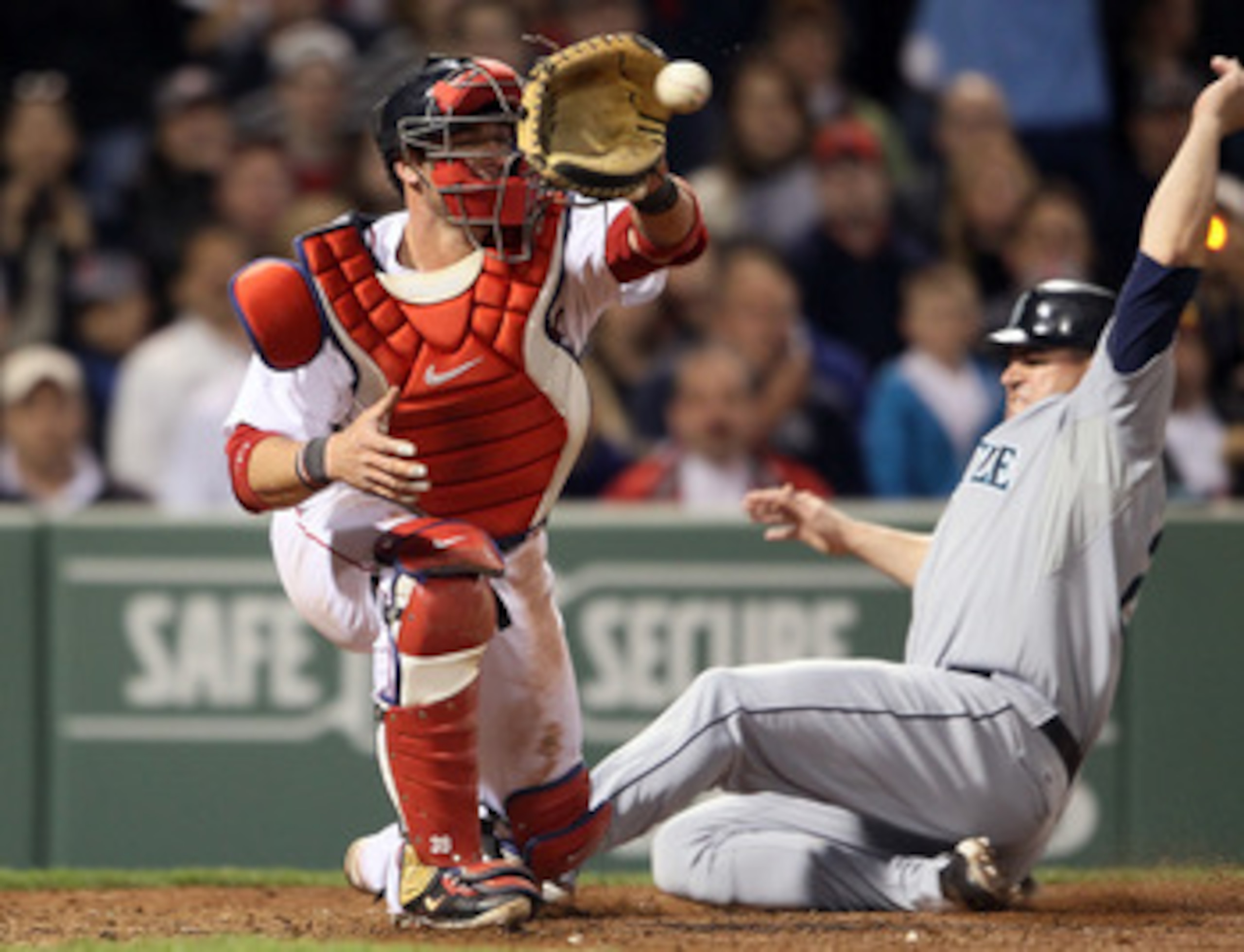 BOSTON, MA - APRIL 30:  Jarrod Saltalamacchia #39 of the Boston Red Sox is unable to make the tag against the Seattle Mariners Jack Cust #29 of the Seattle Mariners is safe at home in the sixth inning on April 30, 2011 at Fenway Park in Boston, Massachuse