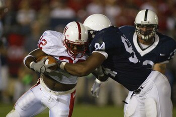 UNIVERSITY PARK, PA - SEPTEMBER 14:  Cory Ross #22 of Nebraska is tackled by Derek Wake #94 of Penn State during the NCAA football game at Beaver Stadium in University Park, Pennsylvania on September 14, 2002. The Penn State Nittany Lions defeated the Neb