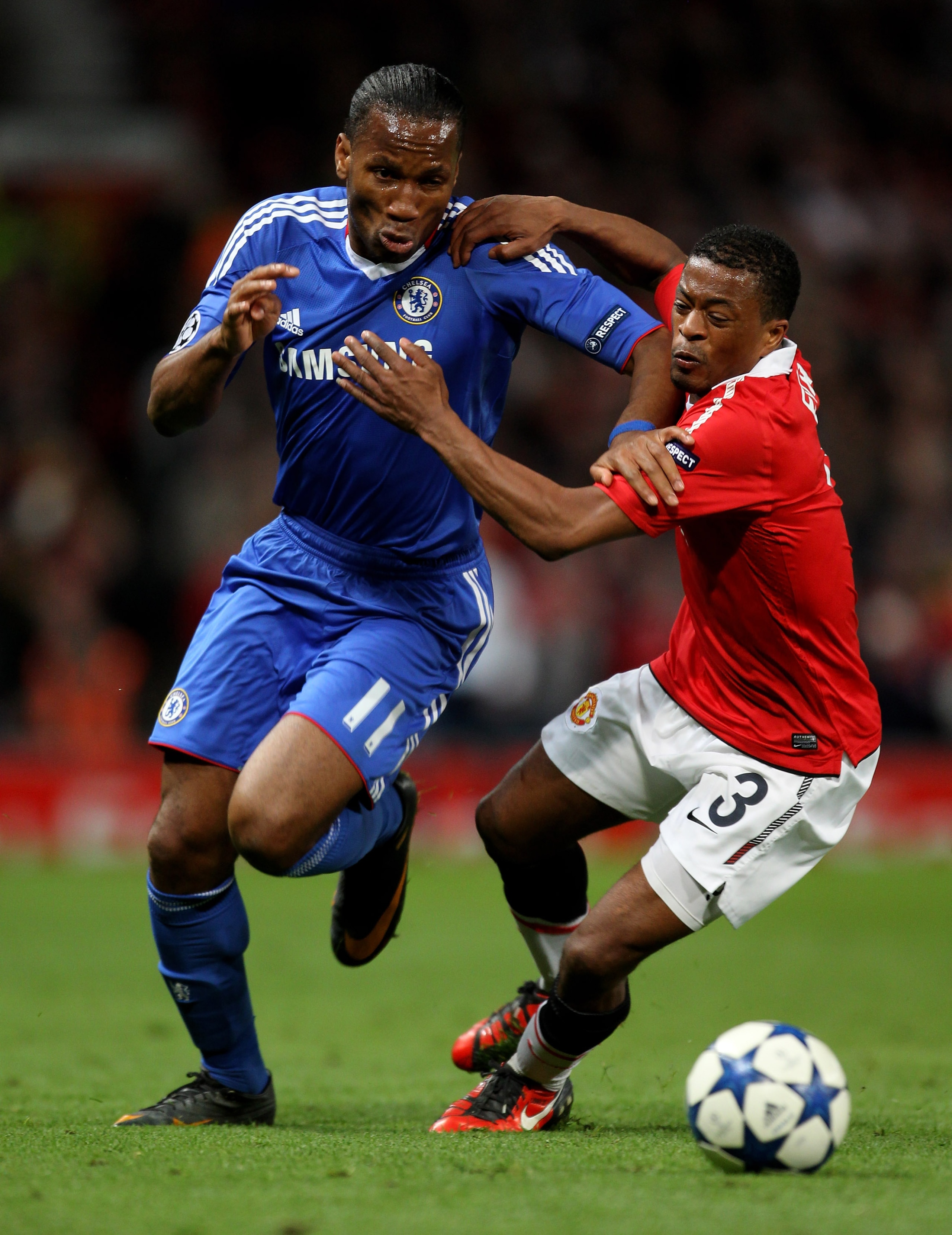 MANCHESTER, ENGLAND - APRIL 12: Didier Drogba of Chelsea is challenged by Patrice Evra of Manchester United during the UEFA Champions League Quarter Final second leg match between Manchester United and Chelsea at Old Trafford on April 12, 2011 in Manches MANCHESTER, ENGLAND - APRIL 12: Didier Drogba of Chelsea is challenged by Patrice Evra of Manchester United during the UEFA Champions League Quarter Final second leg match between Manchester United and Chelsea at Old Trafford on April 12, 2011 in Manches