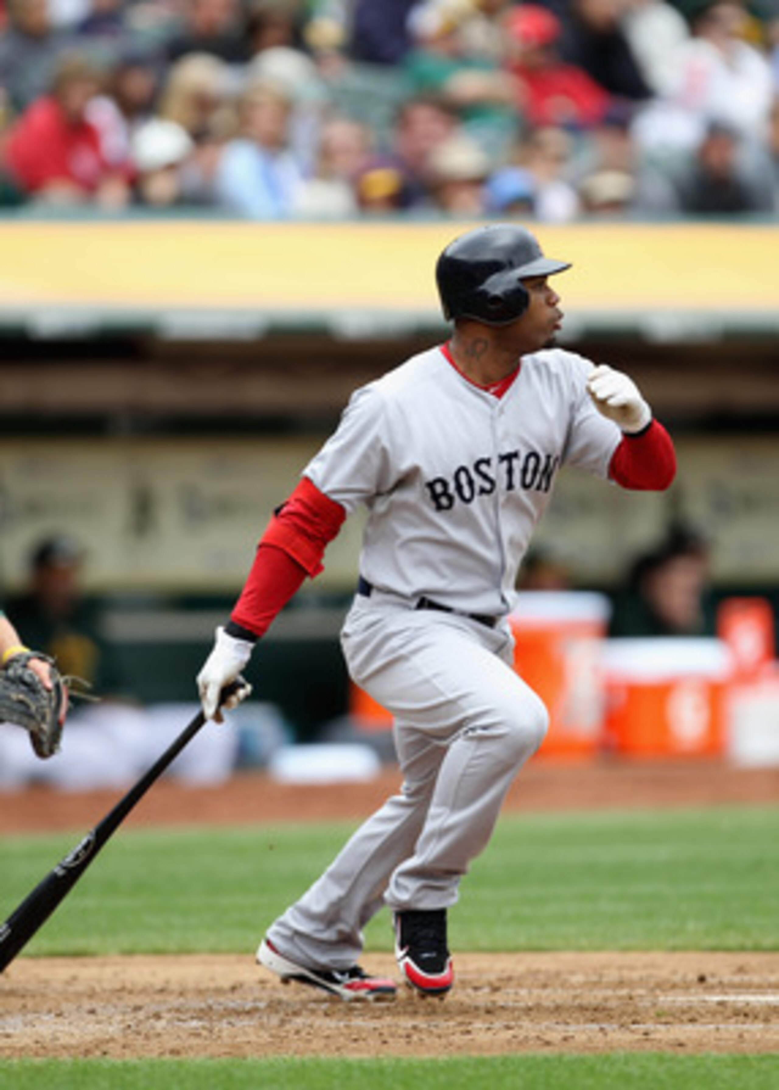OAKLAND, CA - APRIL 20:  Carl Crawford #13 of the Boston Red Sox hits an RBI single that scored Kevin Youkilis #20 during their game against the Oakland Athletics at Oakland-Alameda County Coliseum on April 20, 2011 in Oakland, California.  (Photo by Ezra
