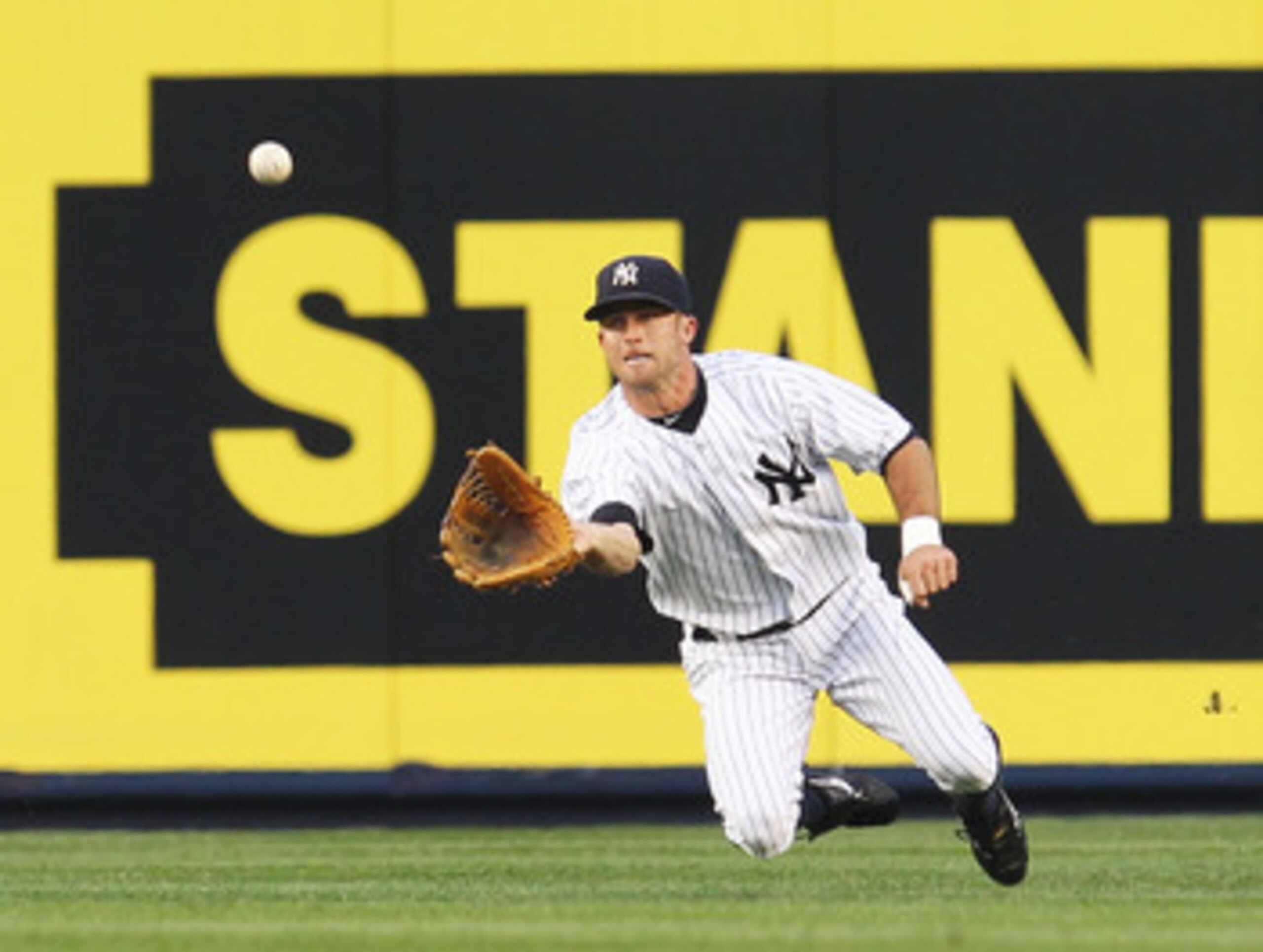 NEW YORK - JUNE 18:  Brett Gardner #11 of the New York Yankees makes a catch against the New York Mets on June 18, 2010 at Yankee Stadium in the Bronx borough of New York City.  (Photo by Al Bello/Getty Images)