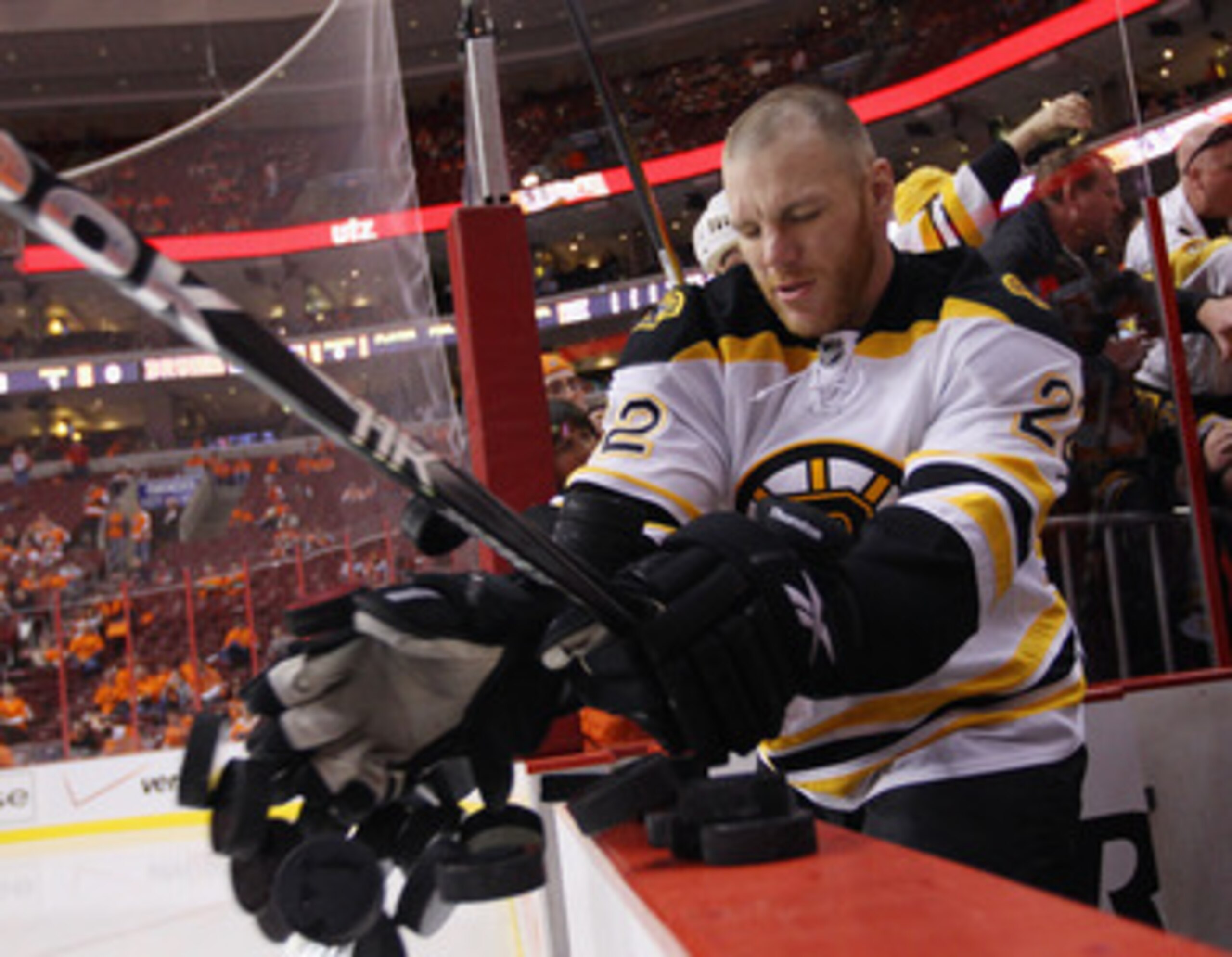 PHILADELPHIA, PA - APRIL 30:  Shawn Thornton #22 of the Boston Bruins tosses pucks onto the ice prior to playing against the Philadelphia Flyers  in Game One of the Eastern Conference Semifinals during the 2011 NHL Stanley Cup Playoffs at the Wells Fargo 