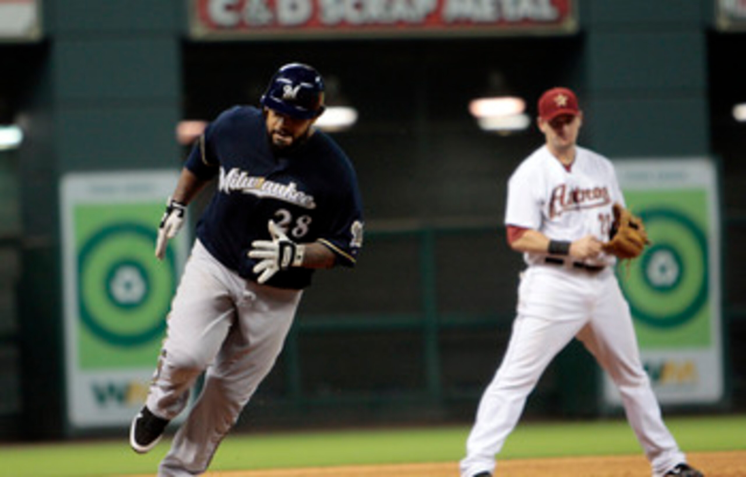 HOUSTON - APRIL 30:  Prince Fielder #28 of the Milwaukee Brewers rounds third base as third baseman Chris Johnson #23 looks on  after hitting a home run in the ninth inning against the Houston Astros at Minute Maid Park on April 30, 2011 in Houston, Texas
