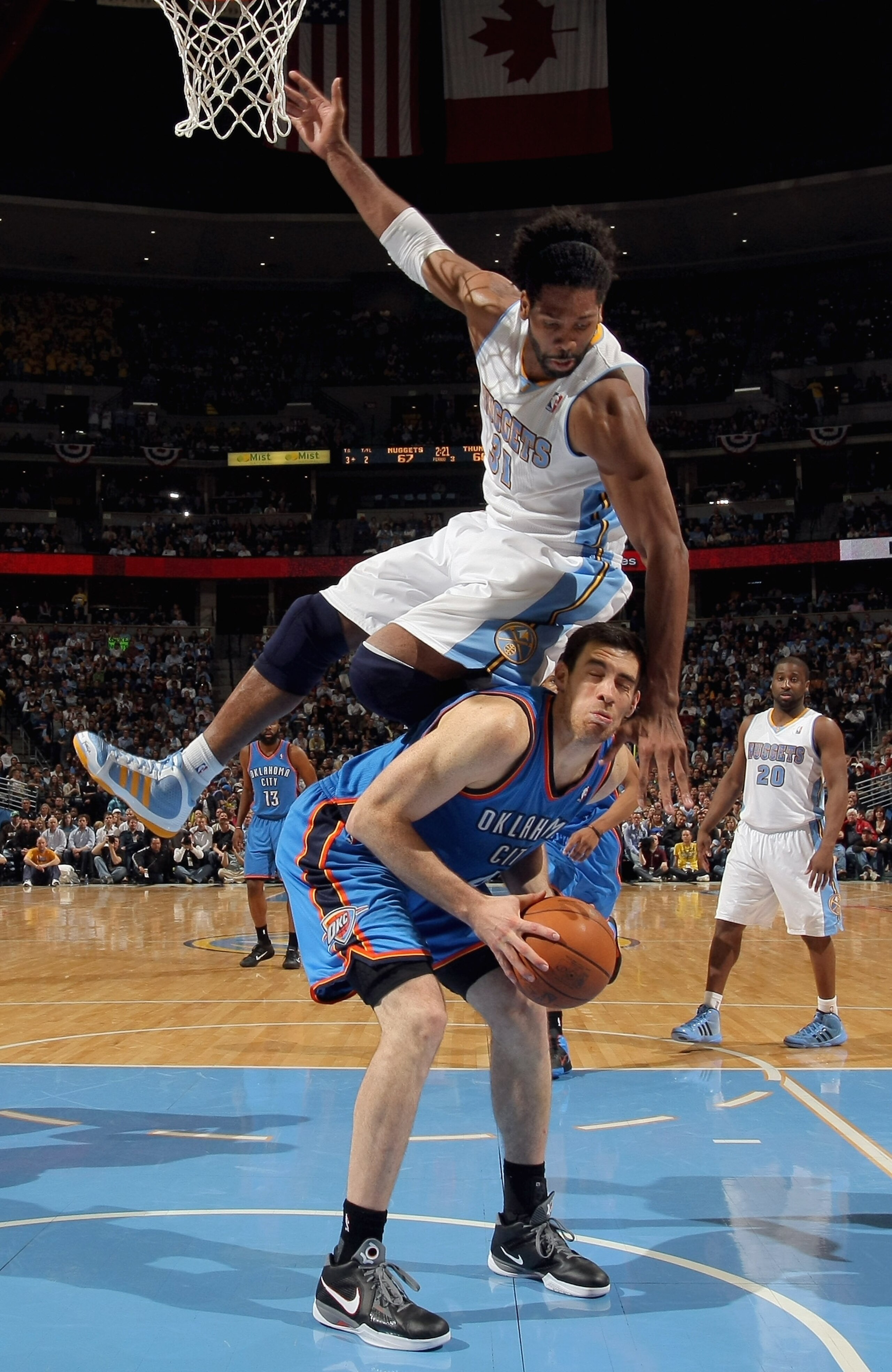 DENVER, CO - APRIL 25: Nick Collison #4 of the Oklahoma City Thunder tries to get off a shot but is fouled by Nene Hilario #31 of the Denver Nuggets in Game Four of the Western Conference Quarterfinals in the 2011 NBA Playoffs on April 24, 2011 at the Pe DENVER, CO - APRIL 25: Nick Collison #4 of the Oklahoma City Thunder tries to get off a shot but is fouled by Nene Hilario #31 of the Denver Nuggets in Game Four of the Western Conference Quarterfinals in the 2011 NBA Playoffs on April 24, 2011 at the Pe