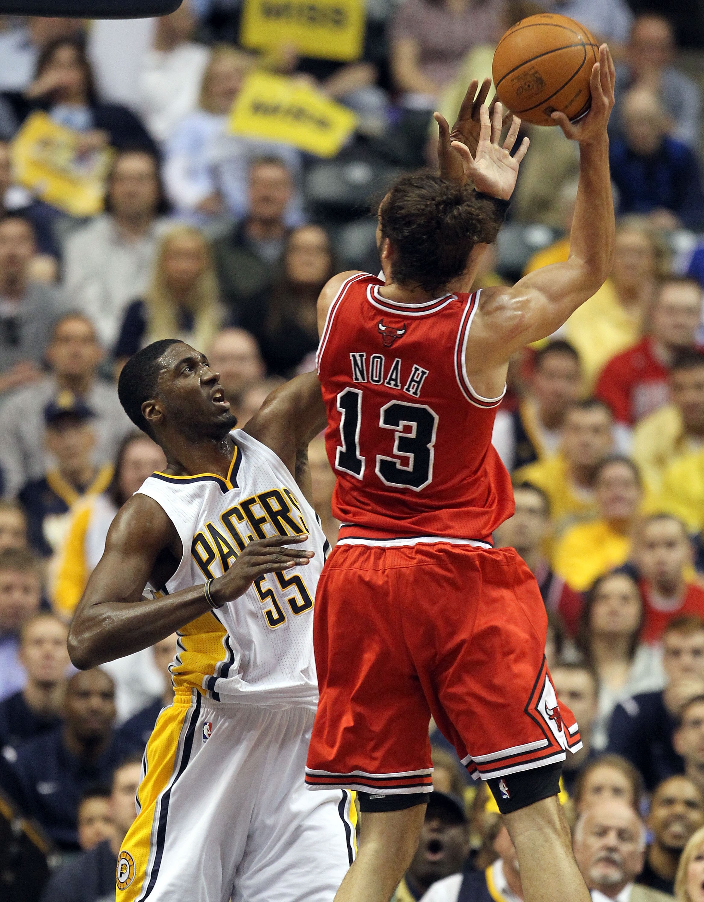 INDIANAPOLIS, IN - APRIL 21:  Roy Hibbert #55 of the Indiana Pacers defends the shot by Joakim Noah #13 of the Chicago Bulls in Game three of the Eastern Conference Quarterfinals in the 2011 NBA Playoffs on April 21, 2011  at Conseco Fieldhouse in Indiana