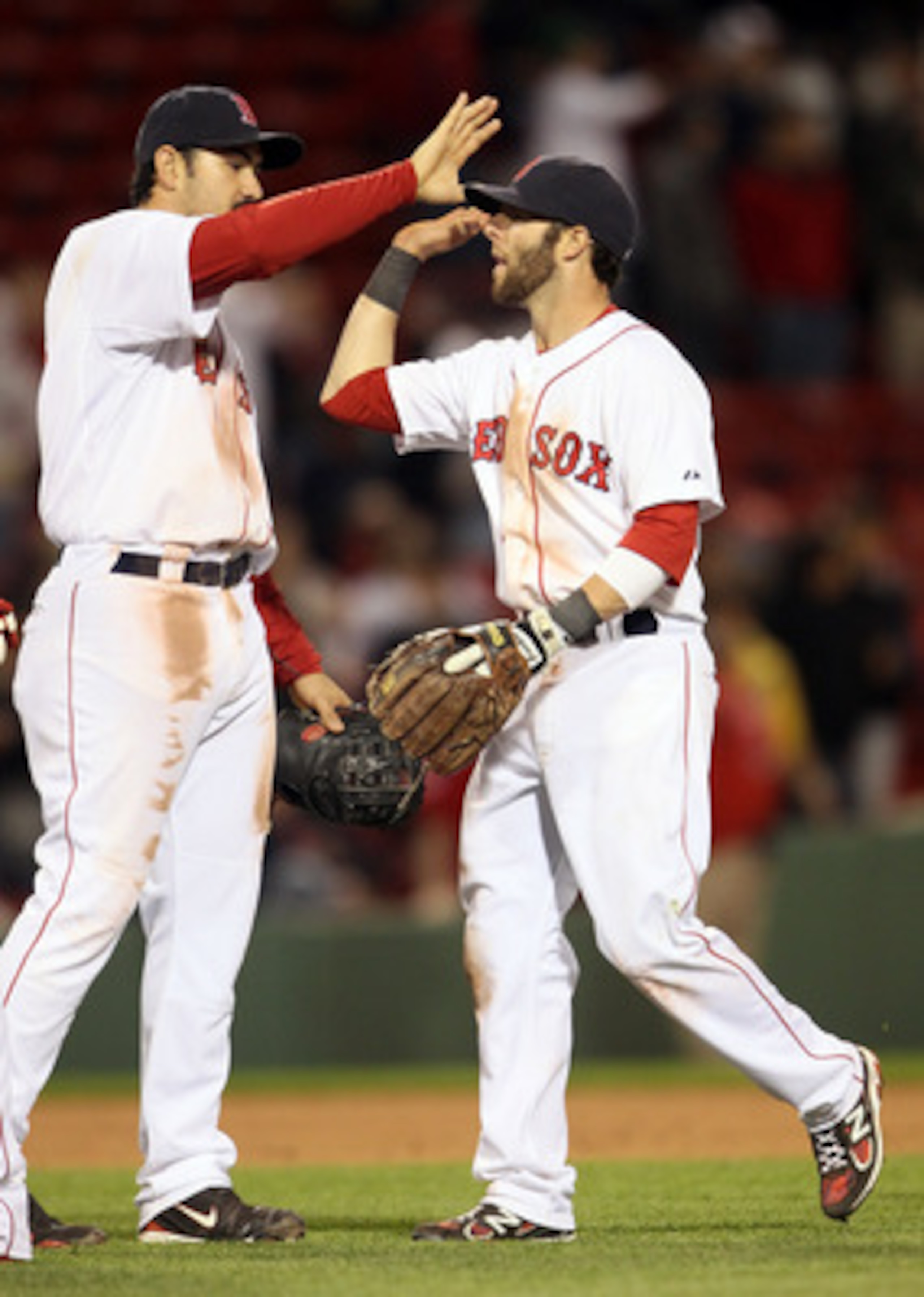 BOSTON, MA - MAY 02:  Adrian Gonzalez #28 and Dustin Pedroia #15 of the Boston Red Sox celebrate the win over the Los Angeles Angels on May 2, 2011 at Fenway Park in Boston, Massachusetts. The Boston Red Sox defeated the Los Angeles Angels 9-5.  (Photo by