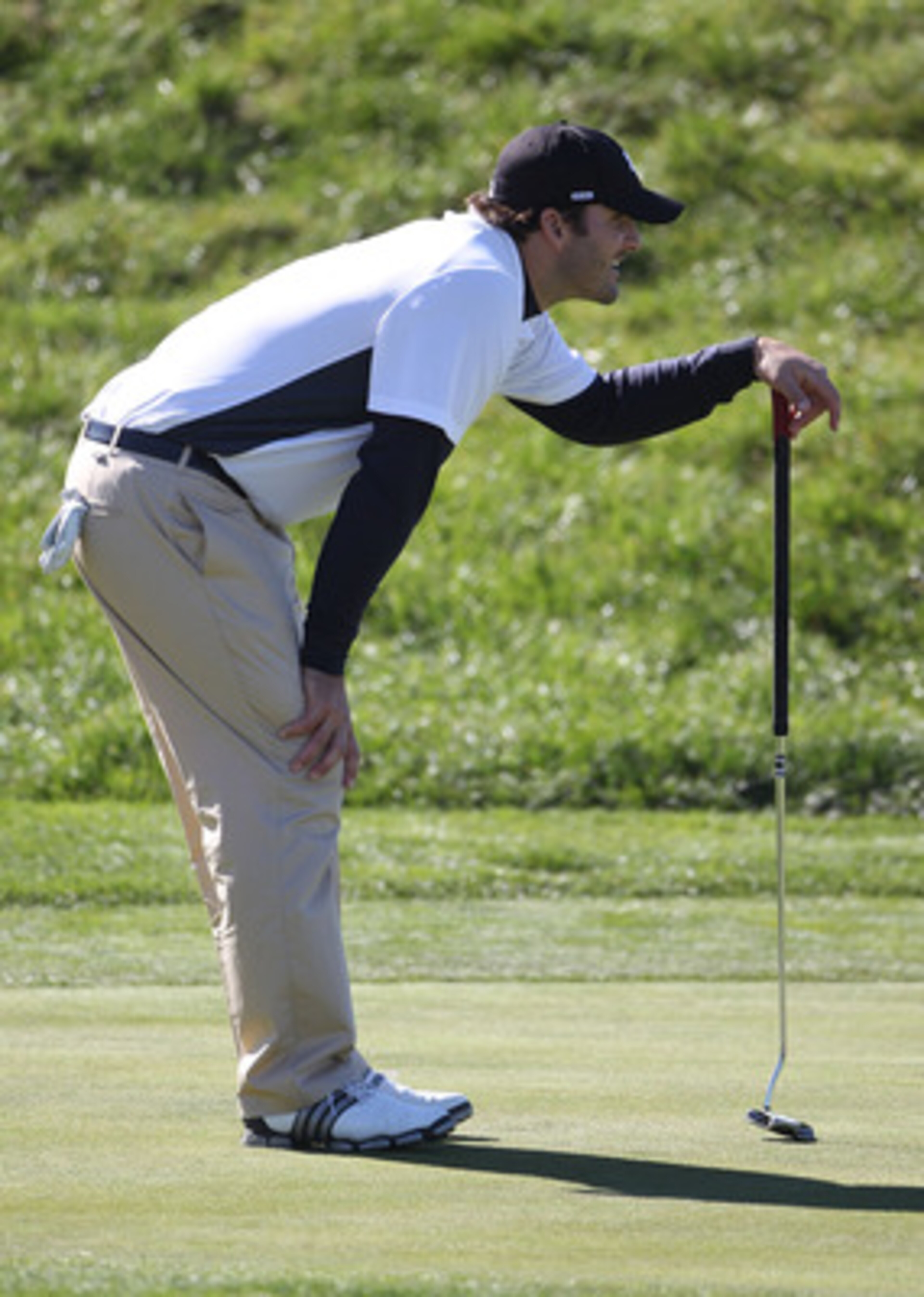PEBBLE BEACH, CA - FEBRUARY 11:  Professional football player Tony Romo lines up a putt at the AT&T Pebble Beach National Pro-Am- Round Two at the Spyglass golf club on February 11, 2011 in Pebble Beach, California.  (Photo by Jed Jacobsohn/Getty Images)