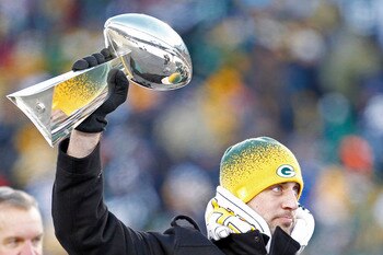 GREEN BAY, WI - FEBRUARY 08:  Green Bay Packers quarterback Aaron Rodgers hoists the Lombardi Trophy during the Packers victory ceremony at Lambeau Field on February 8, 2011 in Green Bay, Wisconsin.  (Photo by Matt Ludtke/Getty Images)