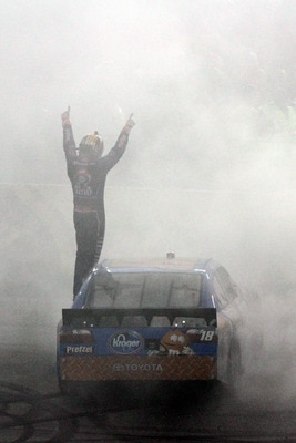 RICHMOND, VA - APRIL 30:  Kyle Busch, driver of the #18 M&M's Pretzel Toyota, celebrates after winning the NASCAR Sprint Cup Series Crown Royal Presents The Matthew & Daniel Hansen 400 at Richmond International Raceway on April 30, 2011 in Richmond, Virgi