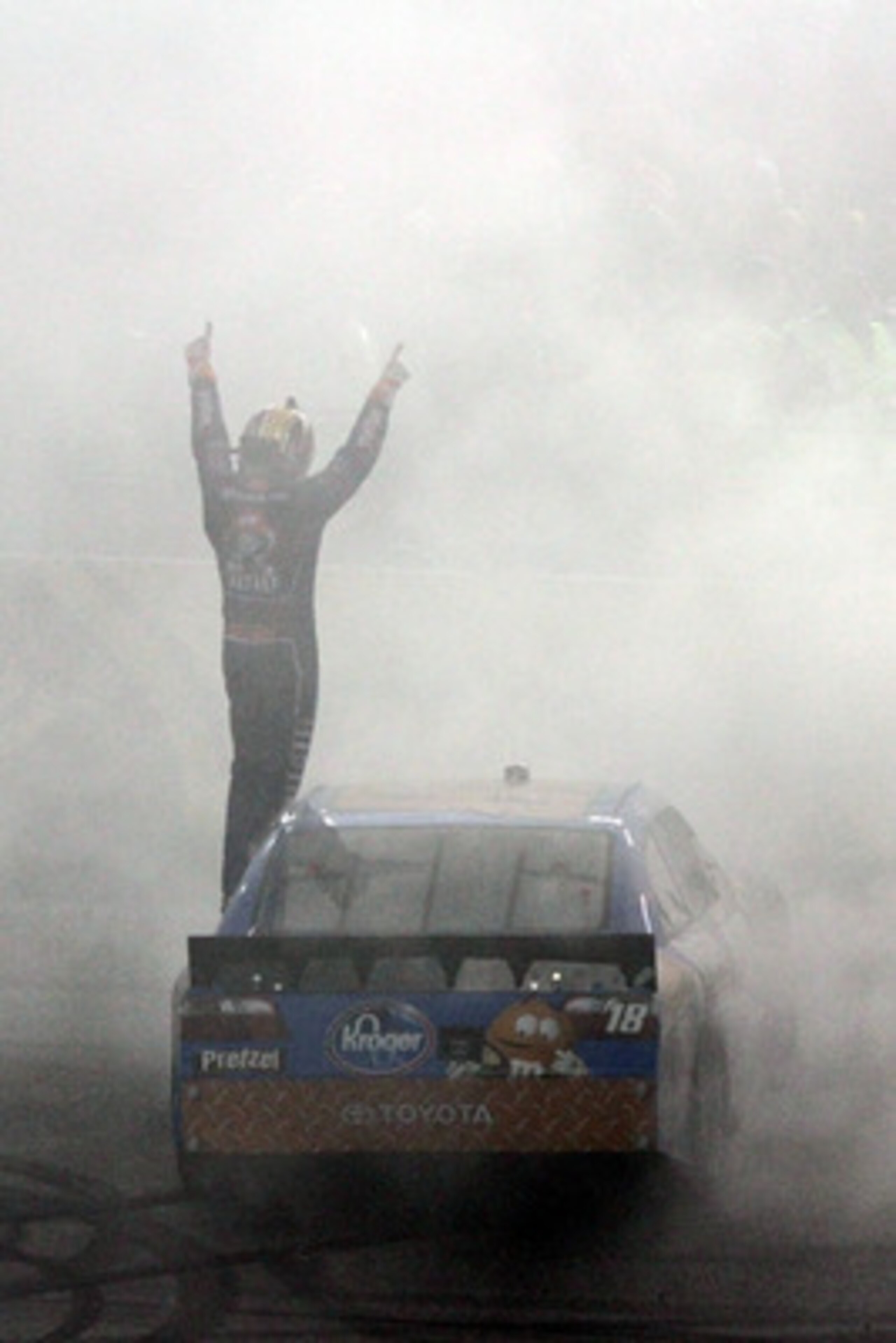 RICHMOND, VA - APRIL 30:  Kyle Busch, driver of the #18 M&M's Pretzel Toyota, celebrates after winning the NASCAR Sprint Cup Series Crown Royal Presents The Matthew & Daniel Hansen 400 at Richmond International Raceway on April 30, 2011 in Richmond, Virgi
