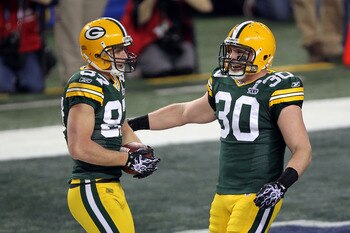 ARLINGTON, TX - FEBRUARY 06: Jordy Nelson #87 and John Kuhn #30 of the Green Bay Packers celebrate after a 29 yard touchdown during Super Bowl XLV at Cowboys Stadium on February 6, 2011 in Arlington, Texas.  (Photo by Mike Ehrmann/Getty Images)