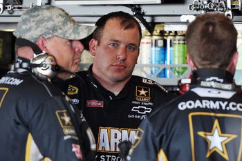 RICHMOND, VA - APRIL 29:  Ryan Newman, driver of the #39 U.S. Army Medicine Chevrolet, stands in the garage with crew members during practice for the NASCAR Sprint Cup Series Crown Royal Presents The Matthew & Daniel Hansen 400 at Richmond International R