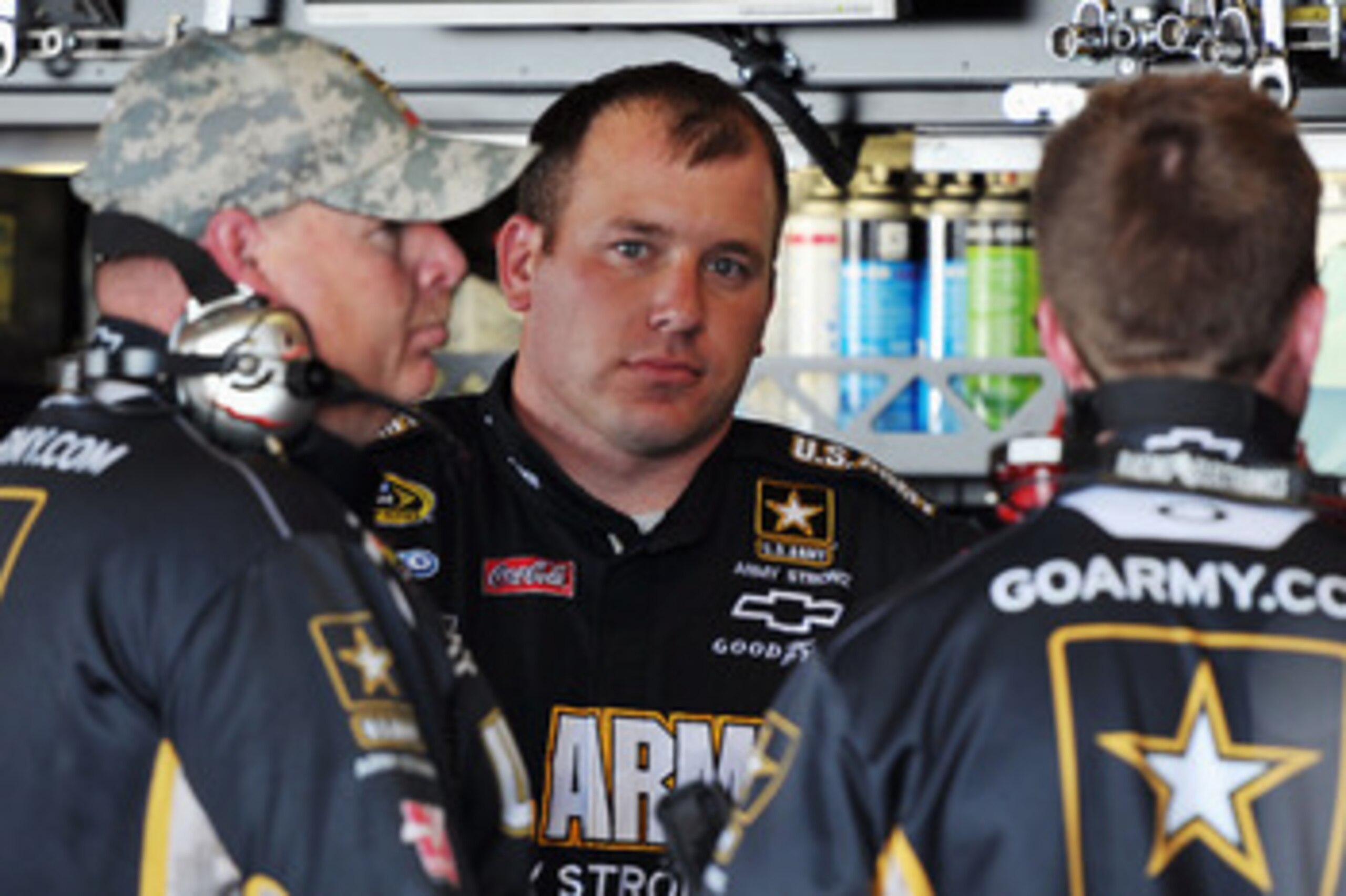 RICHMOND, VA - APRIL 29:  Ryan Newman, driver of the #39 U.S. Army Medicine Chevrolet, stands in the garage with crew members during practice for the NASCAR Sprint Cup Series Crown Royal Presents The Matthew & Daniel Hansen 400 at Richmond International R