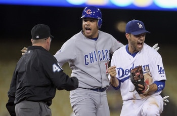 LOS ANGELES, CA - MAY 03:  (L-R) Second base umpire Dale Scott calls out Aramis Ramirez #16 of the Chicago Cubs as Jamey Carroll #14 of the Los Angeles Dodgers reacts in the fourth inning at Dodger Stadium on May 3, 2011 in Los Angeles, California.  (Phot