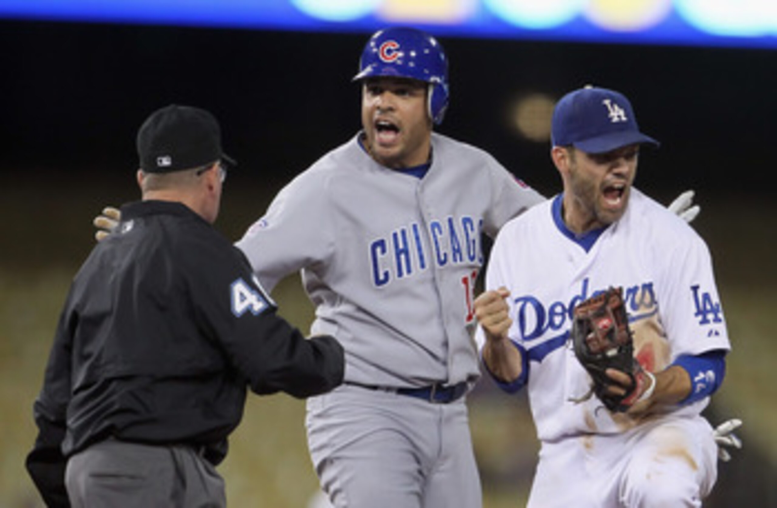 LOS ANGELES, CA - MAY 03:  (L-R) Second base umpire Dale Scott calls out Aramis Ramirez #16 of the Chicago Cubs as Jamey Carroll #14 of the Los Angeles Dodgers reacts in the fourth inning at Dodger Stadium on May 3, 2011 in Los Angeles, California.  (Phot