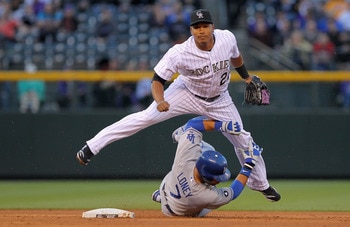 DENVER, CO - APRIL 05:  Second baseman Jose Lopez #22 of the Colorado Rockies and James Loney #7 of the Los Angeles Dodgers collide as Lopez turns a double play on a ground ball by Juan Uribe of the Dodgers to third baseman Ty Wigginton of the Rockies  in