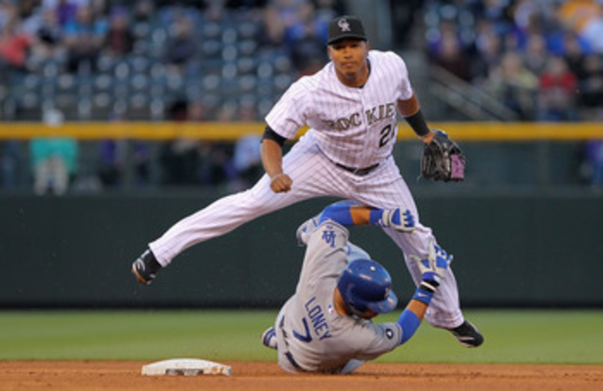 DENVER, CO - APRIL 05:  Second baseman Jose Lopez #22 of the Colorado Rockies and James Loney #7 of the Los Angeles Dodgers collide as Lopez turns a double play on a ground ball by Juan Uribe of the Dodgers to third baseman Ty Wigginton of the Rockies  in