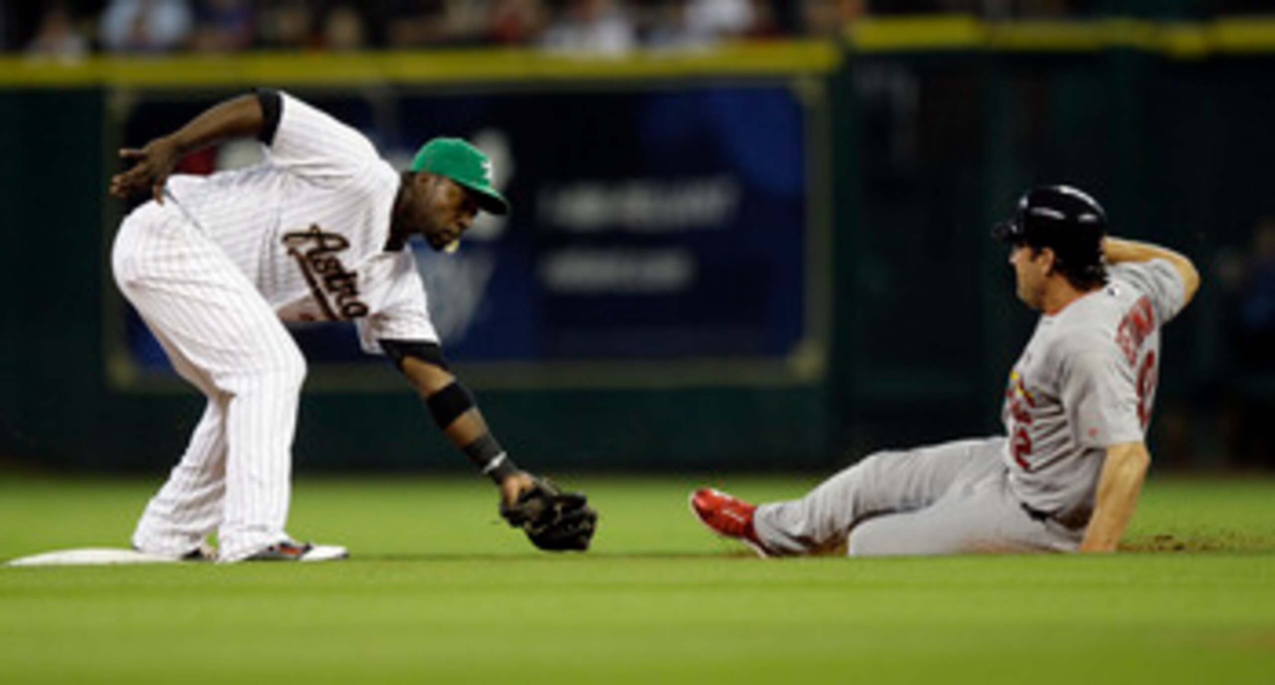HOUSTON - APRIL 26:  Lance Berkman #12 of the St. Louis Cardinals is tagged out attempting to steal second by second baseman Bill Hall #22 of the Houston Astros in the second inning at Minute Maid Park on April 26, 2011 in Houston, Texas.  (Photo by Bob L