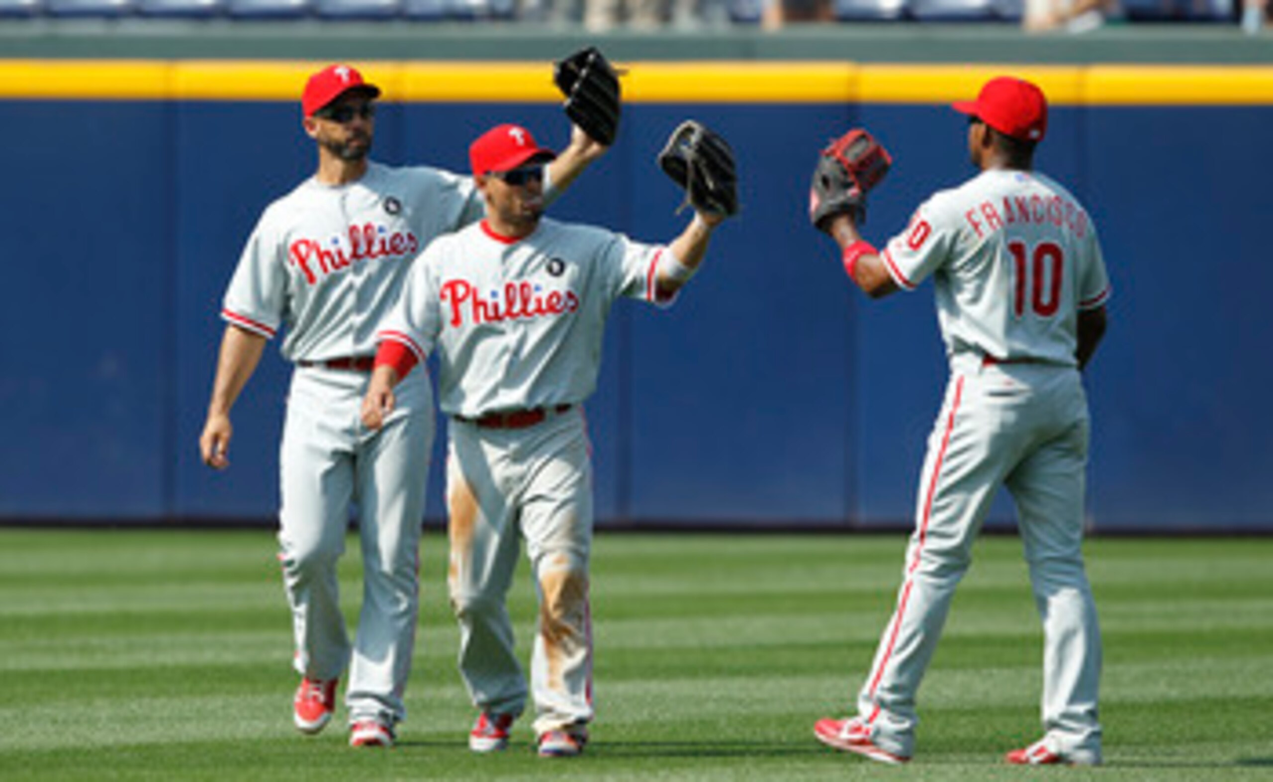 ATLANTA, GA - APRIL 9: Shane Victorino #8, Raul Ibanez #29 and Ben Francisco #10 of the Philadelphia Phillies celebrate after the game against the Atlanta Braves at Turner Field on April 9, 2011 in Atlanta, Georgia. The Phillies won 10-2. (Photo by Joe Ro