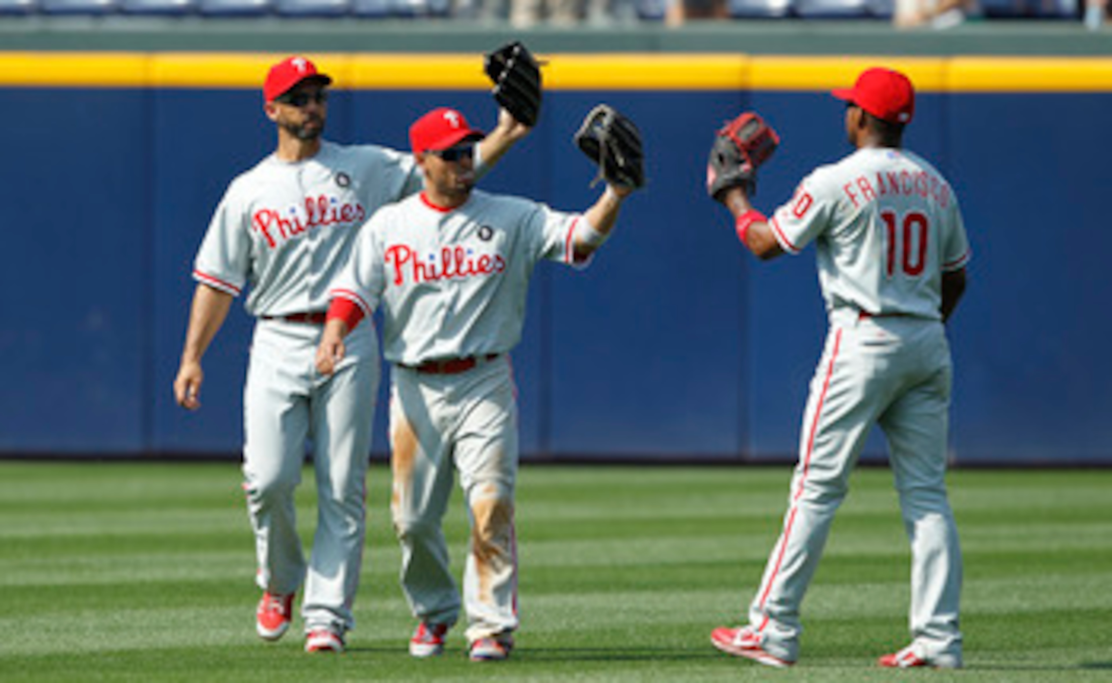 ATLANTA, GA - APRIL 9: Shane Victorino #8, Raul Ibanez #29 and Ben Francisco #10 of the Philadelphia Phillies celebrate after the game against the Atlanta Braves at Turner Field on April 9, 2011 in Atlanta, Georgia. The Phillies won 10-2. (Photo by Joe Ro