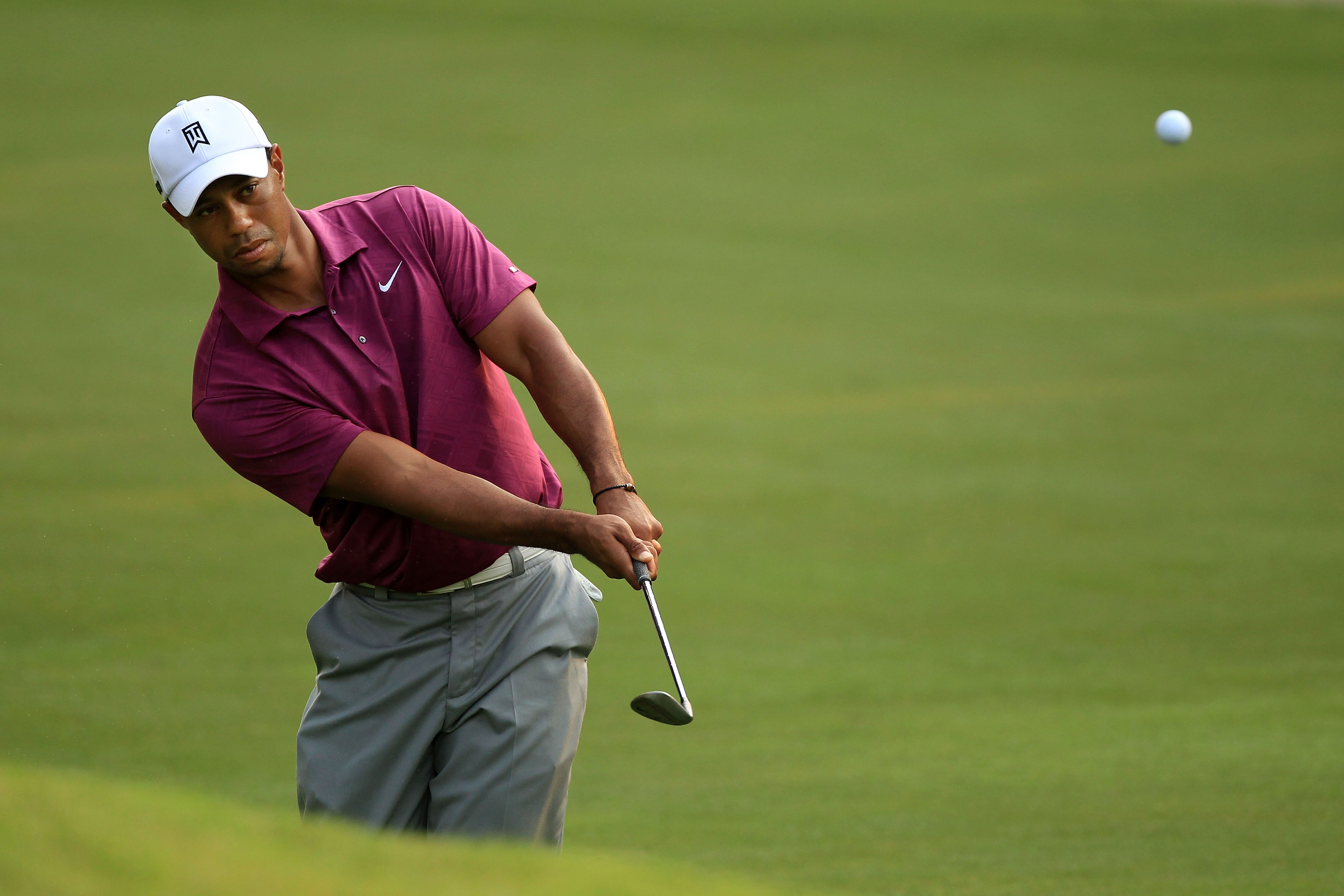 PONTE VEDRA BEACH, FL - MAY 11:  Tiger Woods hits a chip shot during a practice round prior to the start of THE PLAYERS Championship held at THE PLAYERS Stadium course at TPC Sawgrass on May 11, 2011 in Ponte Vedra Beach, Florida.  (Photo by Streeter Leck