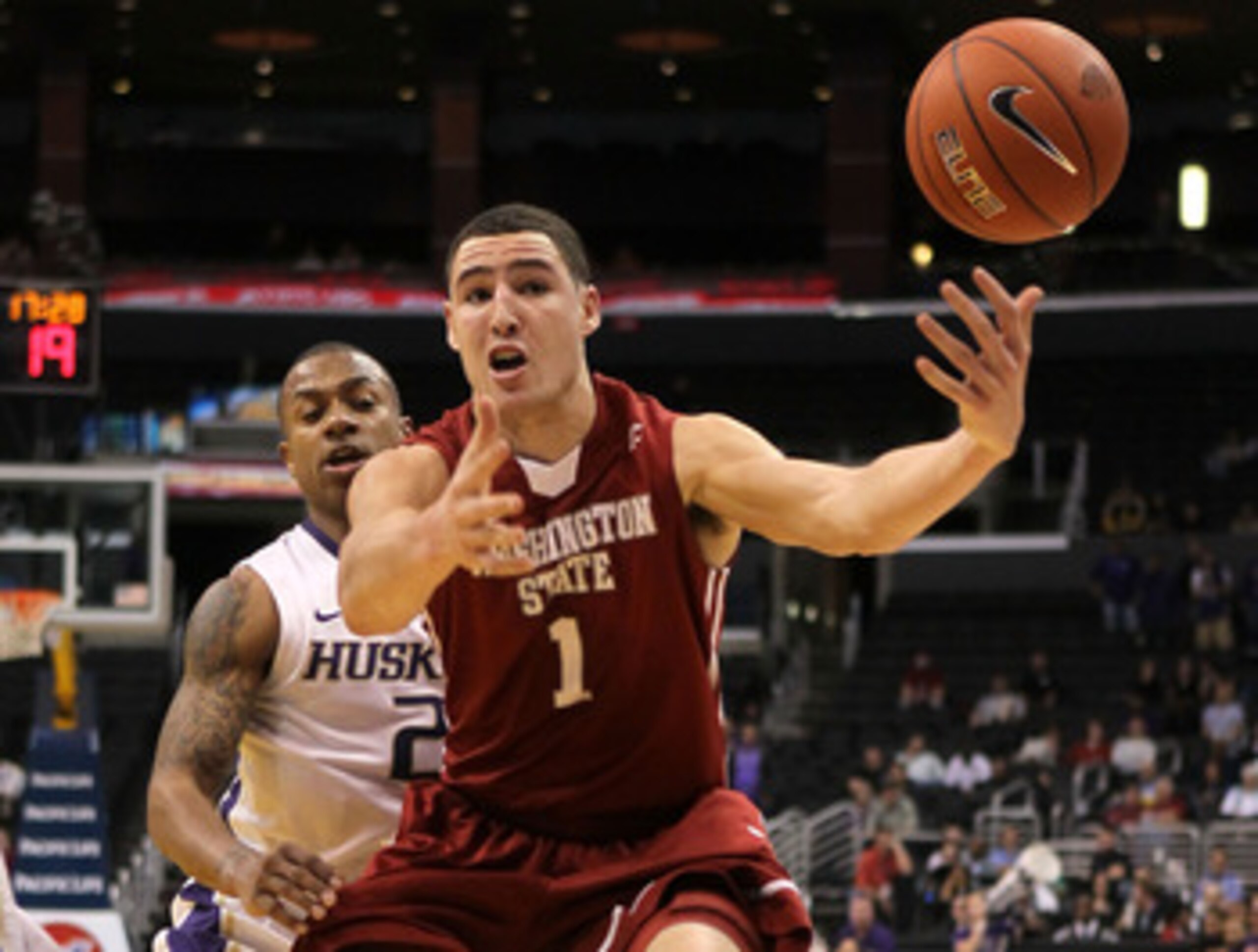 LOS ANGELES, CA - MARCH 10:  Klay Thompson #1 of the Washington State Cougars goes after the ball in front of Isaiah Thomas #2 of the Washington Huskies in the second half in the quarterfinals of the 2011 Pacific Life Pac-10 Men's Basketball Tournament at