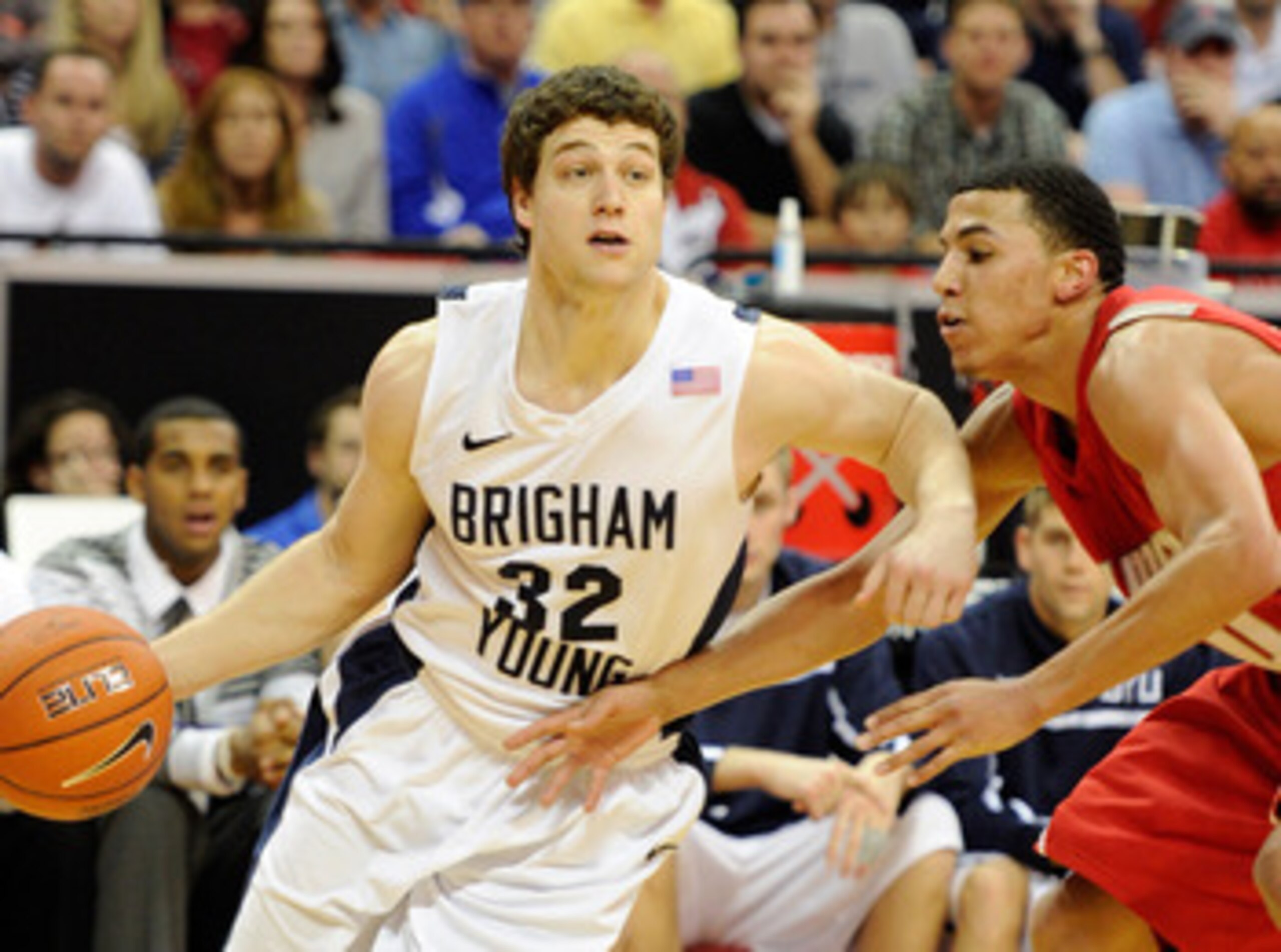 LAS VEGAS, NV - MARCH 11:  Jimmer Fredette #32 of the Brigham Young University Cougars drives against Kendall Williams #10 of the New Mexico Lobos during a semifinal game of the Conoco Mountain West Conference Basketball tournament at the Thomas & Mack Ce