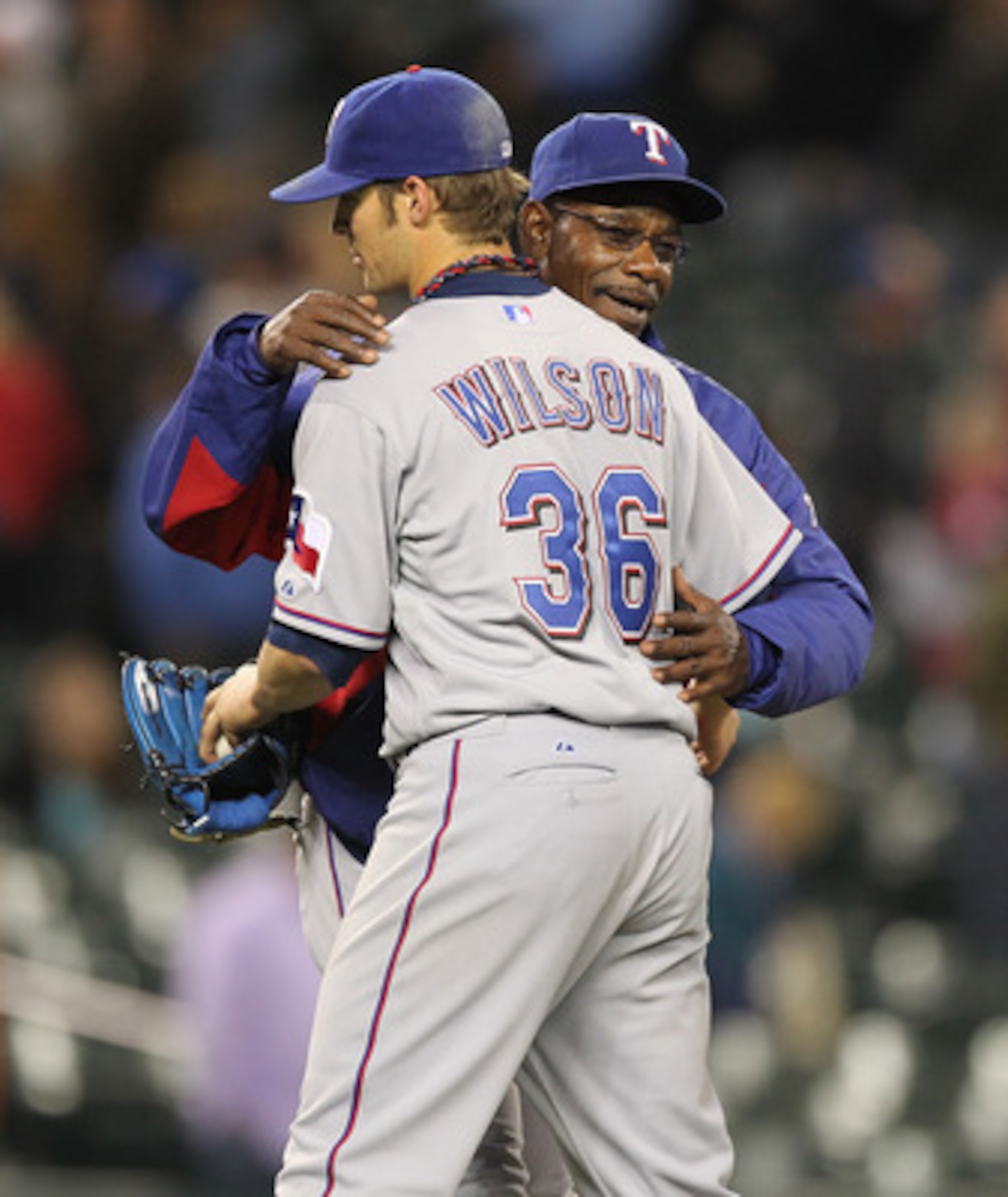 SEATTLE - MAY 04:  Starting pitcher C.J. Wilson #36 of the Texas Rangers gets a hug from manager Ron Washington #38 after throwing a complete game to defeat the Seattle Mariners 5-2 at Safeco Field on May 4, 2011 in Seattle, Washington. (Photo by Otto Gre