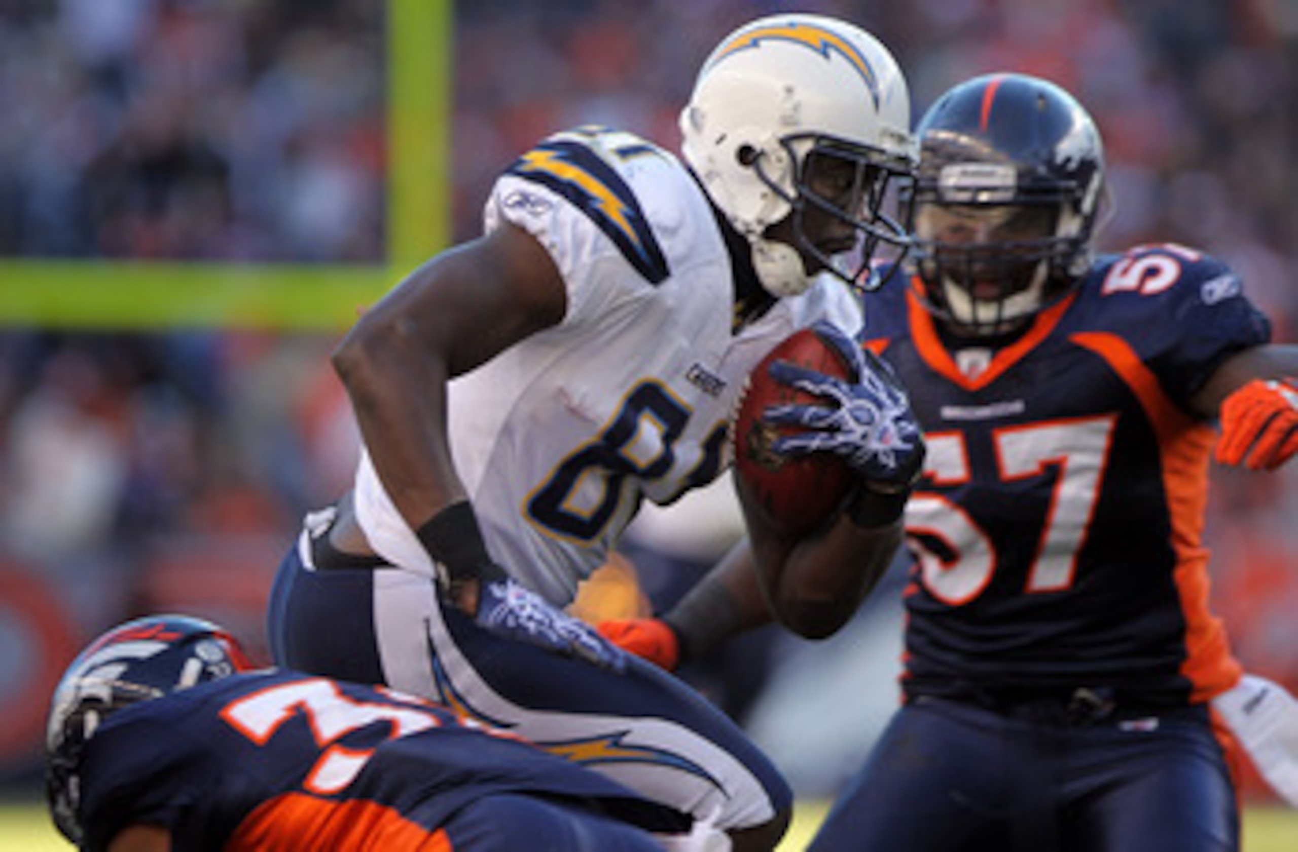 DENVER - JANUARY 02:  Wide receiver Randy McMichael #81 of the San Diego Chargers makes a 17 yard first down reception as linebacker Mario Haggan #57 of the Denver Broncos moves in for the tackle at INVESCO Field at Mile High on January 2, 2011 in Denver,