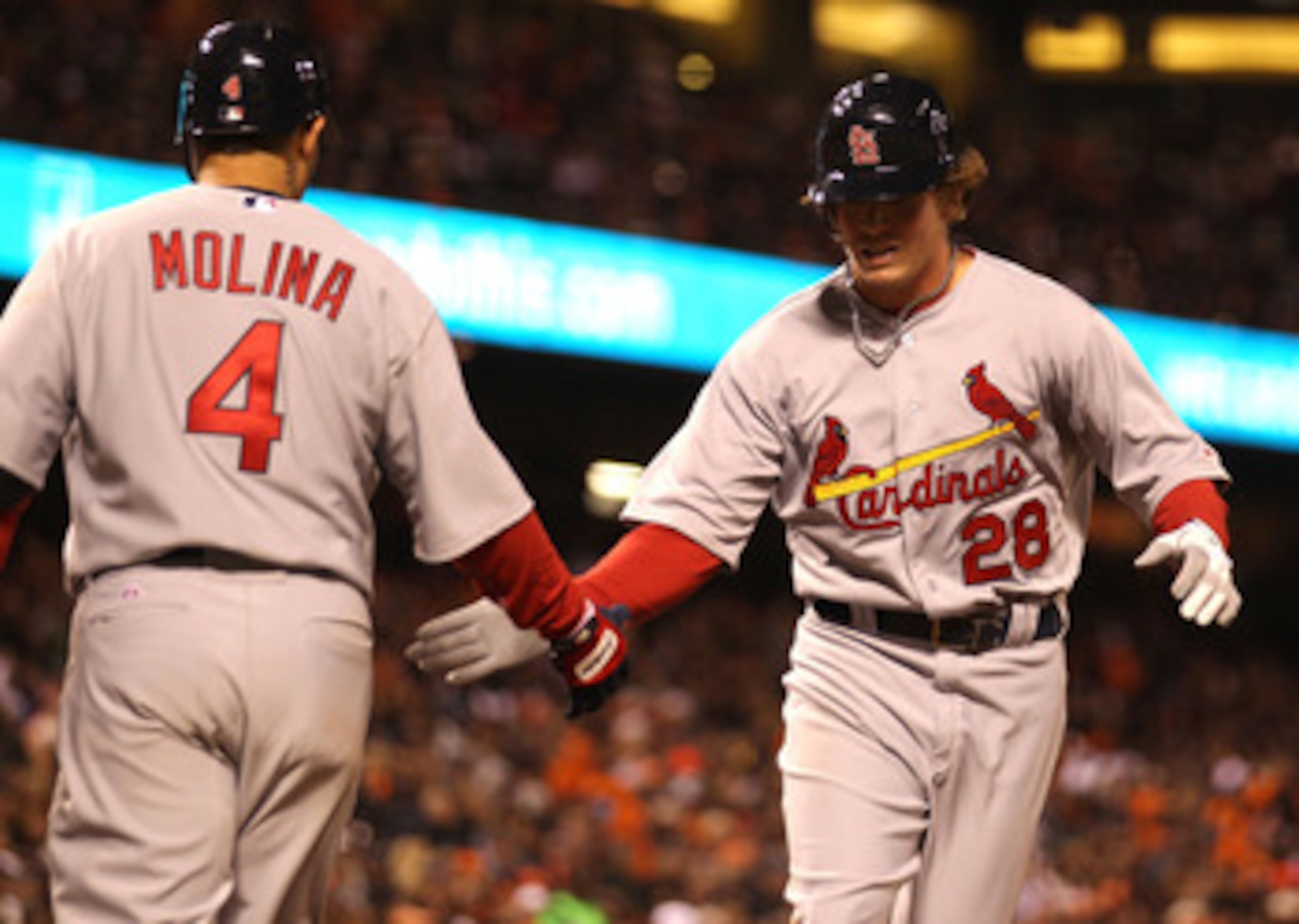 SAN FRANCISCO, CA - APRIL 09:  Colby Rasmus #28 of the St. Louis Cardinals celebrates with Yadier Molina #4 after hitting a home run against the San Francisco Giants at AT&T Park on April 9, 2011 in San Francisco, California.  (Photo by Jed Jacobsohn/Gett