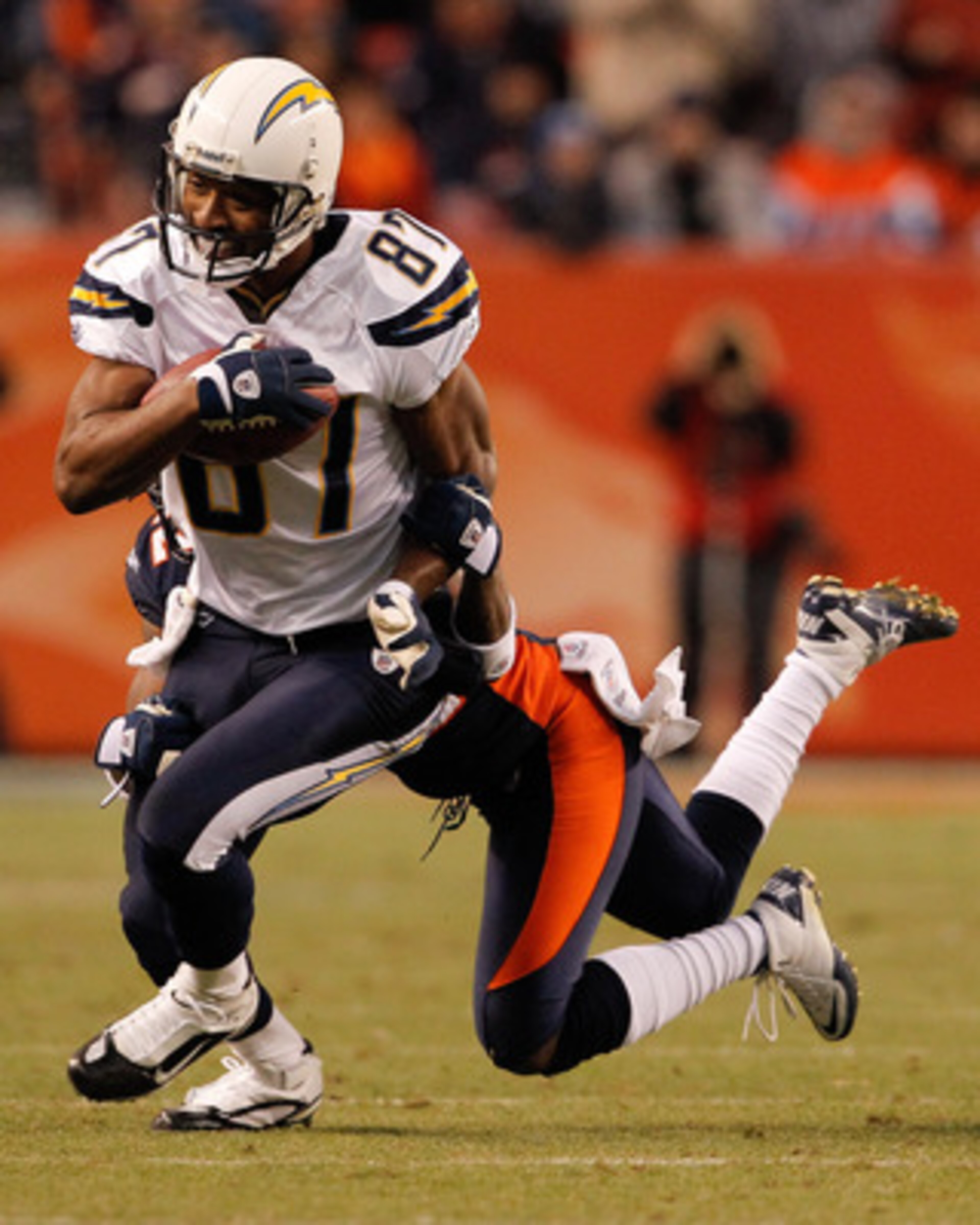 DENVER, CO - JANUARY 2:  Wide receiver Kelley Washington #87 of the San Diego Chargers is tackled after a reception by cornerback Syd'Quan Thompson #22 of the Denver Broncos during the fourth quarter at INVESCO Field at Mile High on January 2, 2011 in Den