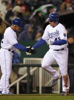 KANSAS CITY, MO - APRIL 15:  Jeff Francoeur #42 of the Kansas City Royals rounds the bases and is congratulated by third base coach Eddie Rodriguez #42 after hitting a home run during the game against the Seattle Mariners at Kauffman Stadium on April 15,