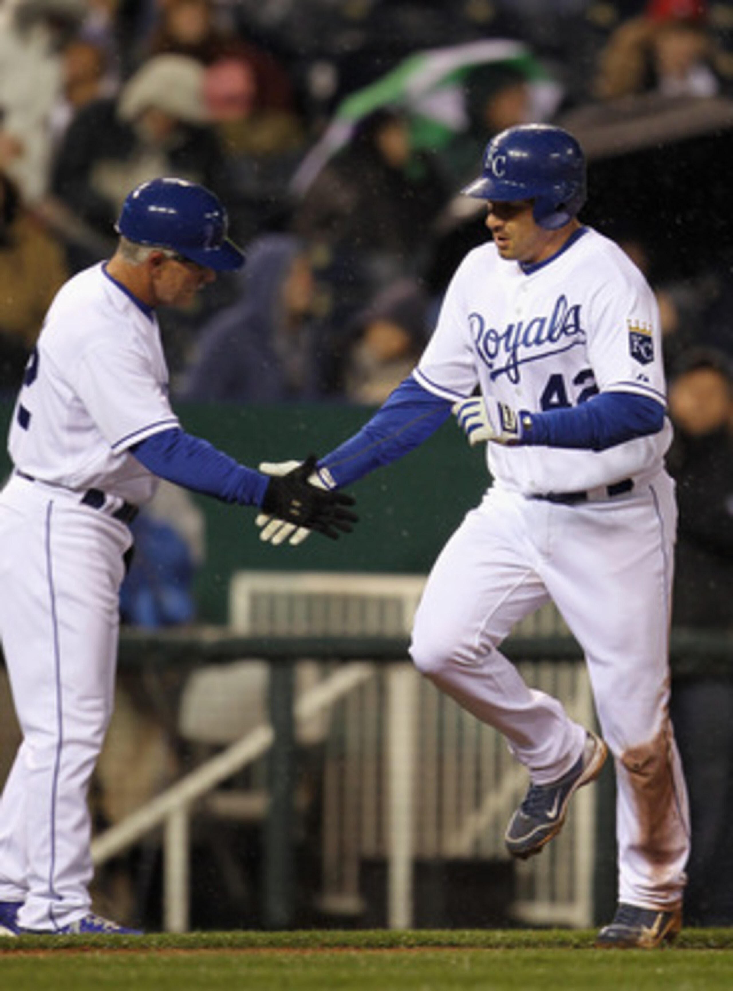 KANSAS CITY, MO - APRIL 15:  Jeff Francoeur #42 of the Kansas City Royals rounds the bases and is congratulated by third base coach Eddie Rodriguez #42 after hitting a home run during the game against the Seattle Mariners at Kauffman Stadium on April 15,